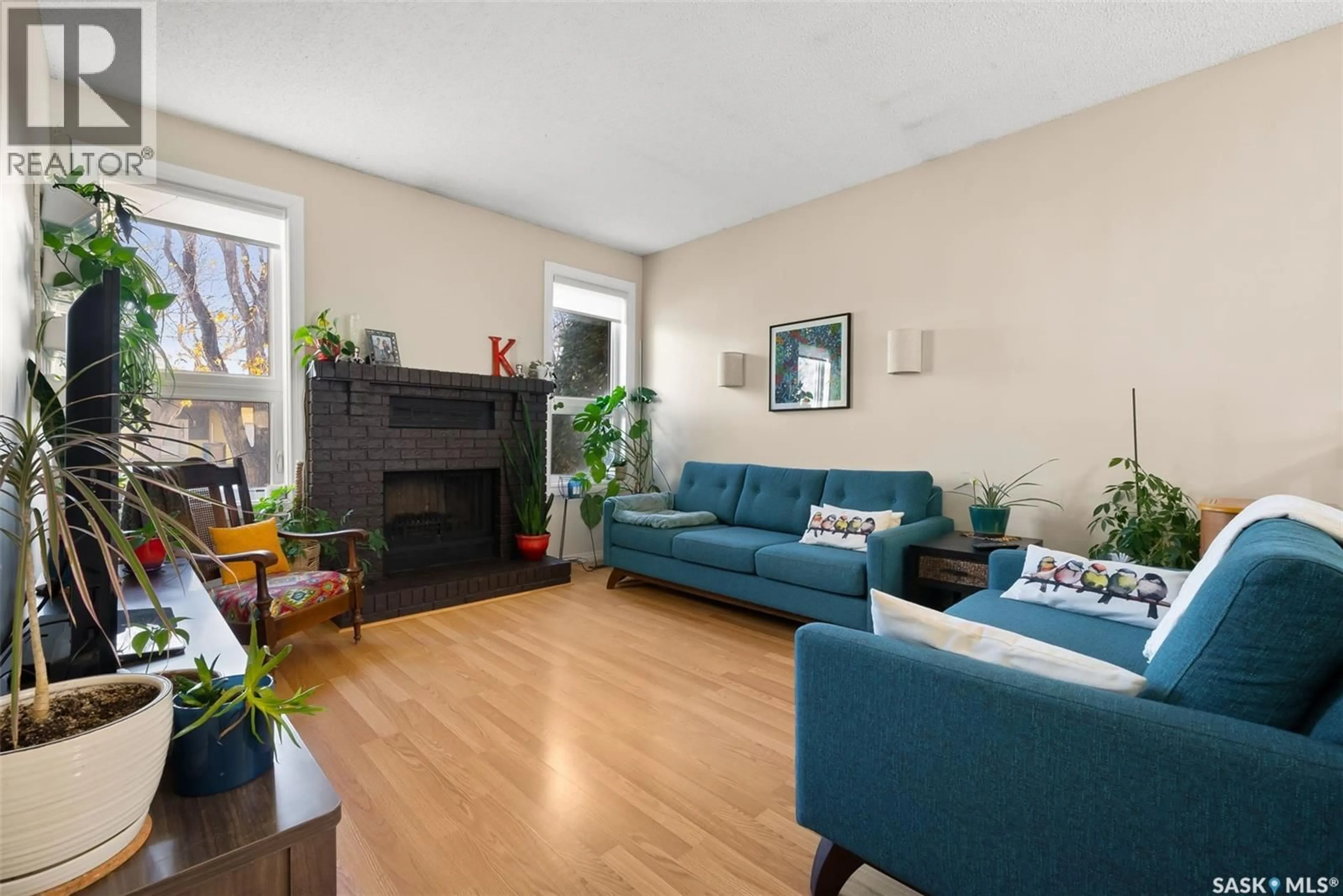 Living room with furniture, wood/laminate floor for 30 SHERMAN ROAD, Regina Saskatchewan S4X2R8