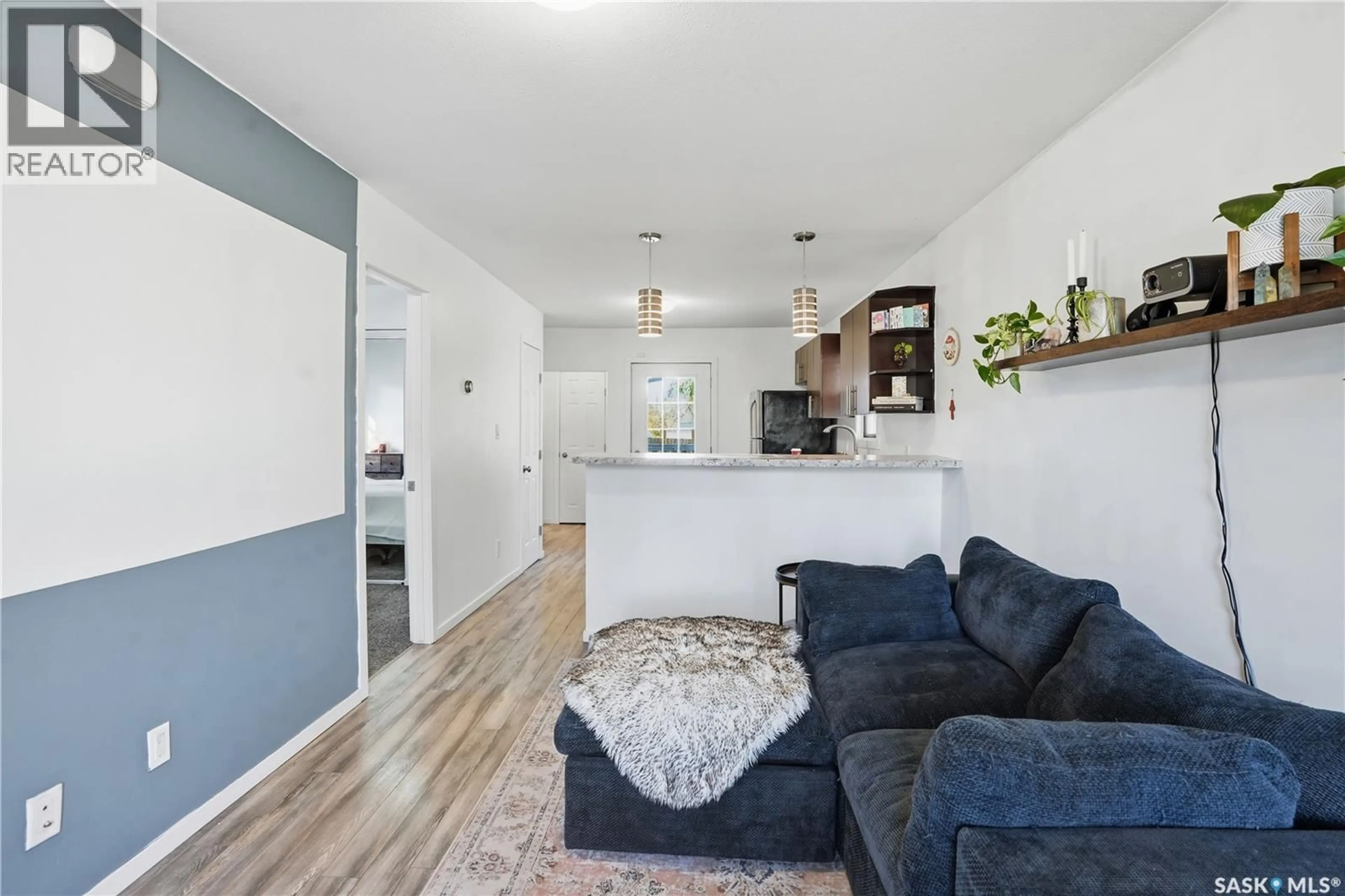 Living room with furniture, wood/laminate floor for 5023 8TH AVENUE, Regina Saskatchewan S4T0W4