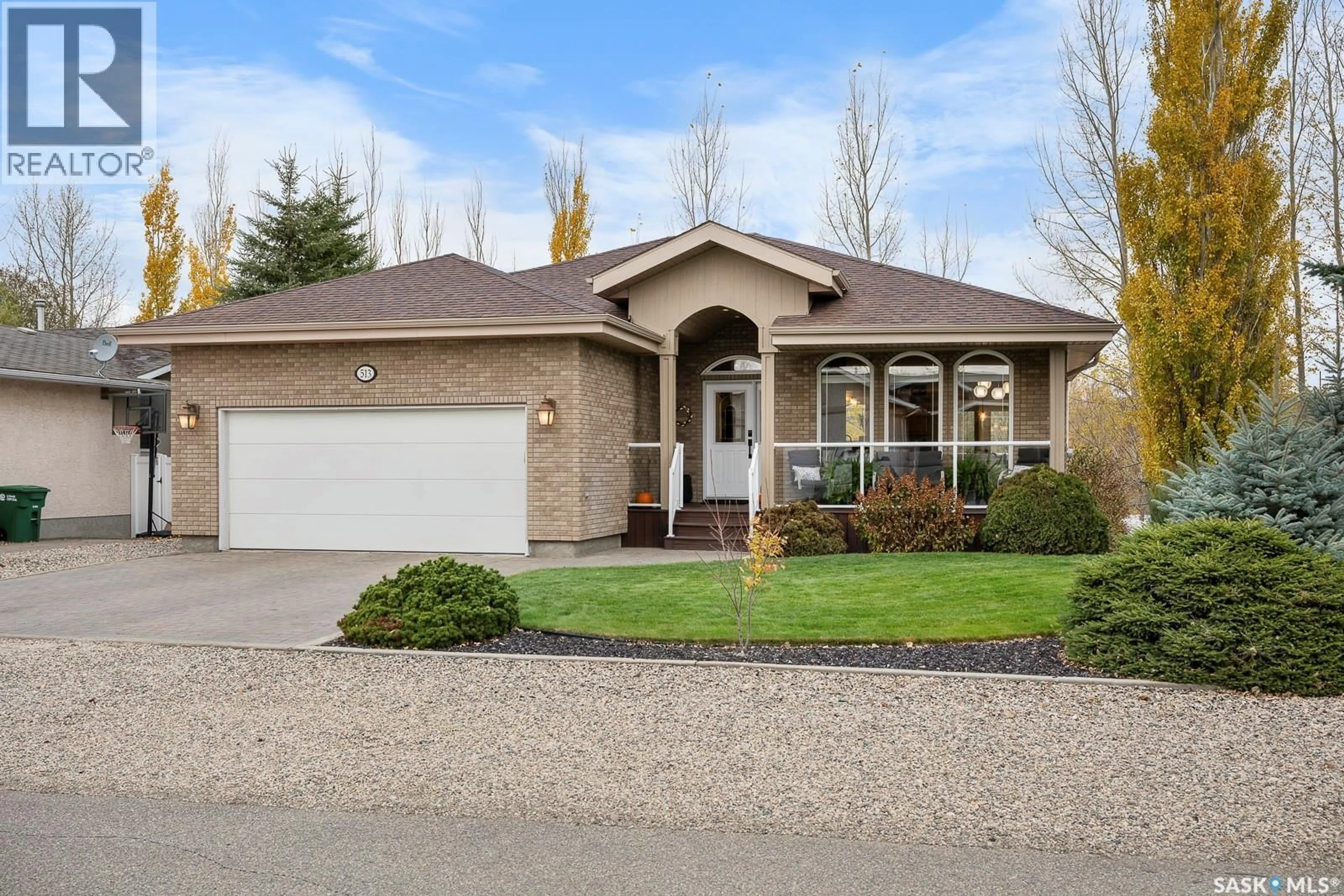 Home with vinyl exterior material, street for 513 MEADOW ROAD, Pilot Butte Saskatchewan S0G3Z0