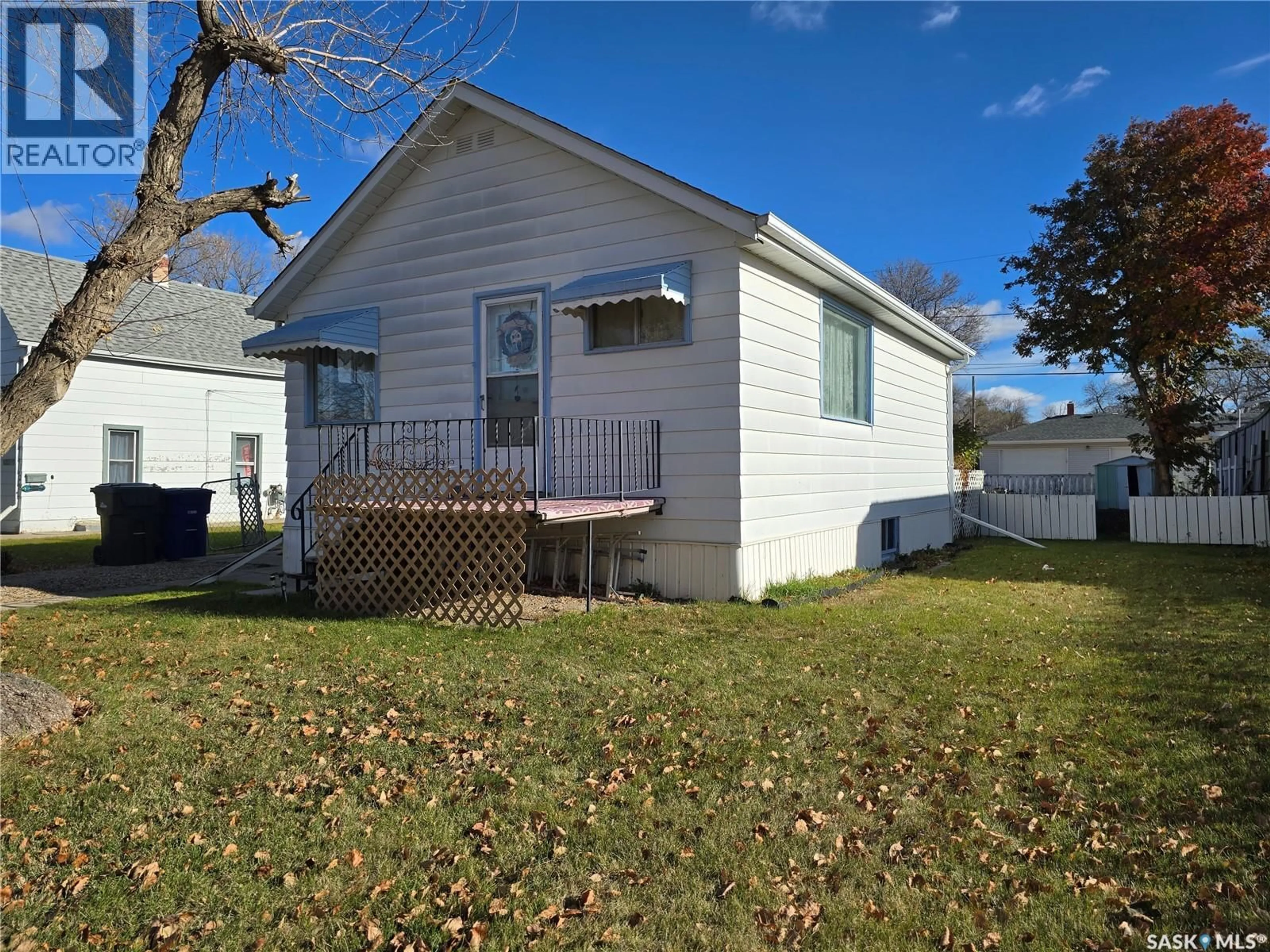 Home with vinyl exterior material, street for 124 10TH STREET, Weyburn Saskatchewan S4H1G9