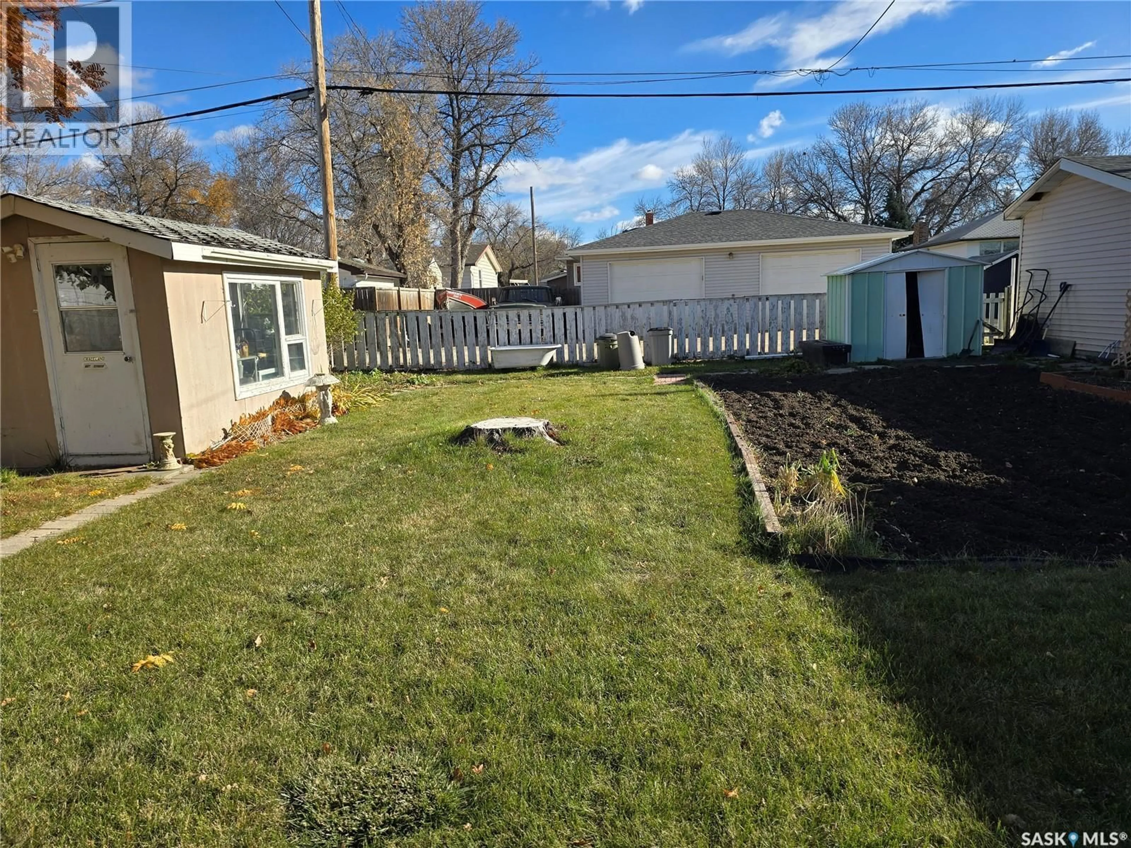 A pic from outside/outdoor area/front of a property/back of a property/a pic from drone, street for 124 10TH STREET, Weyburn Saskatchewan S4H1G9