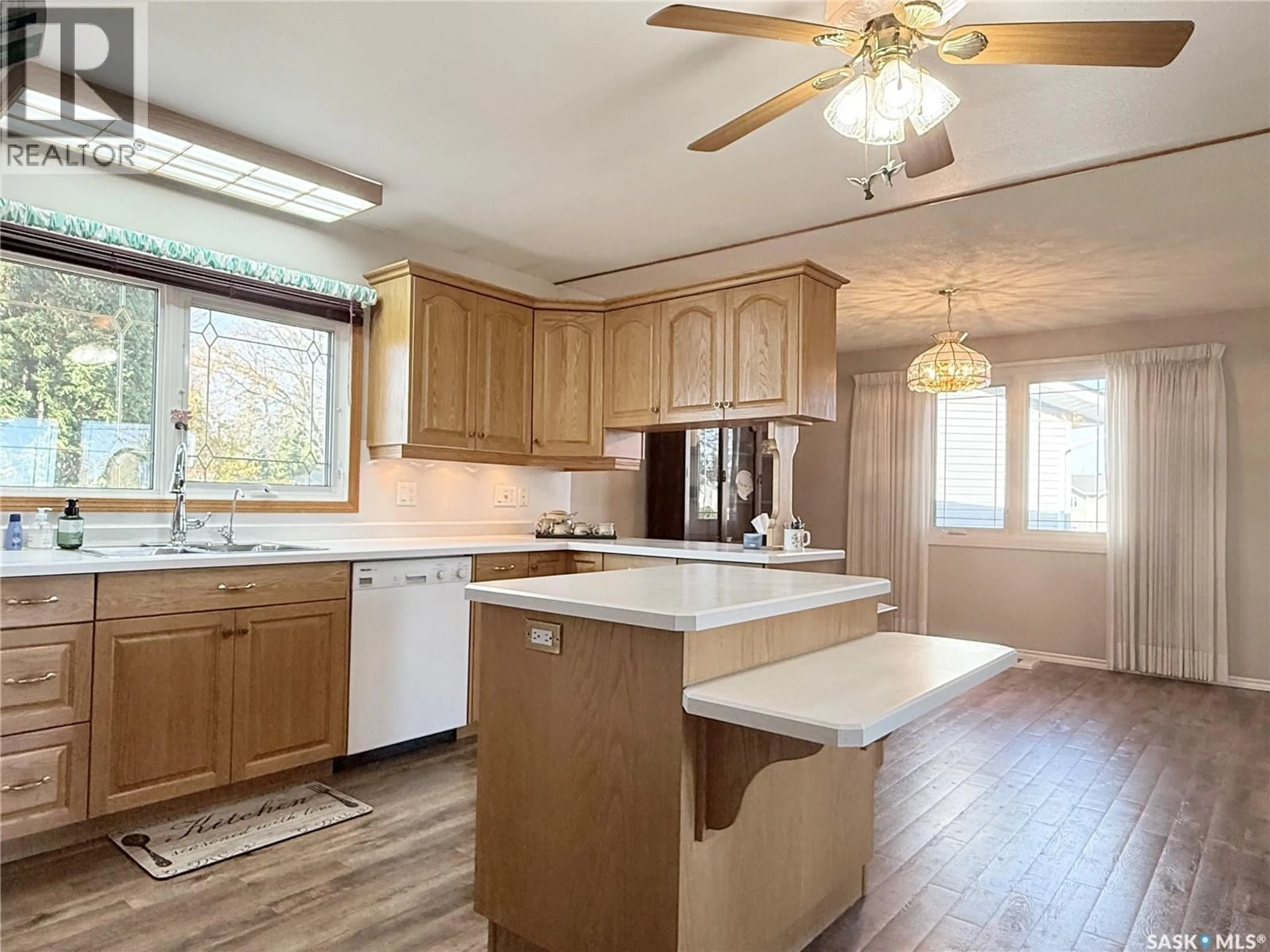 Open concept kitchen, wood/laminate floor for 505 9TH AVENUE, Melville Saskatchewan S0A2P0