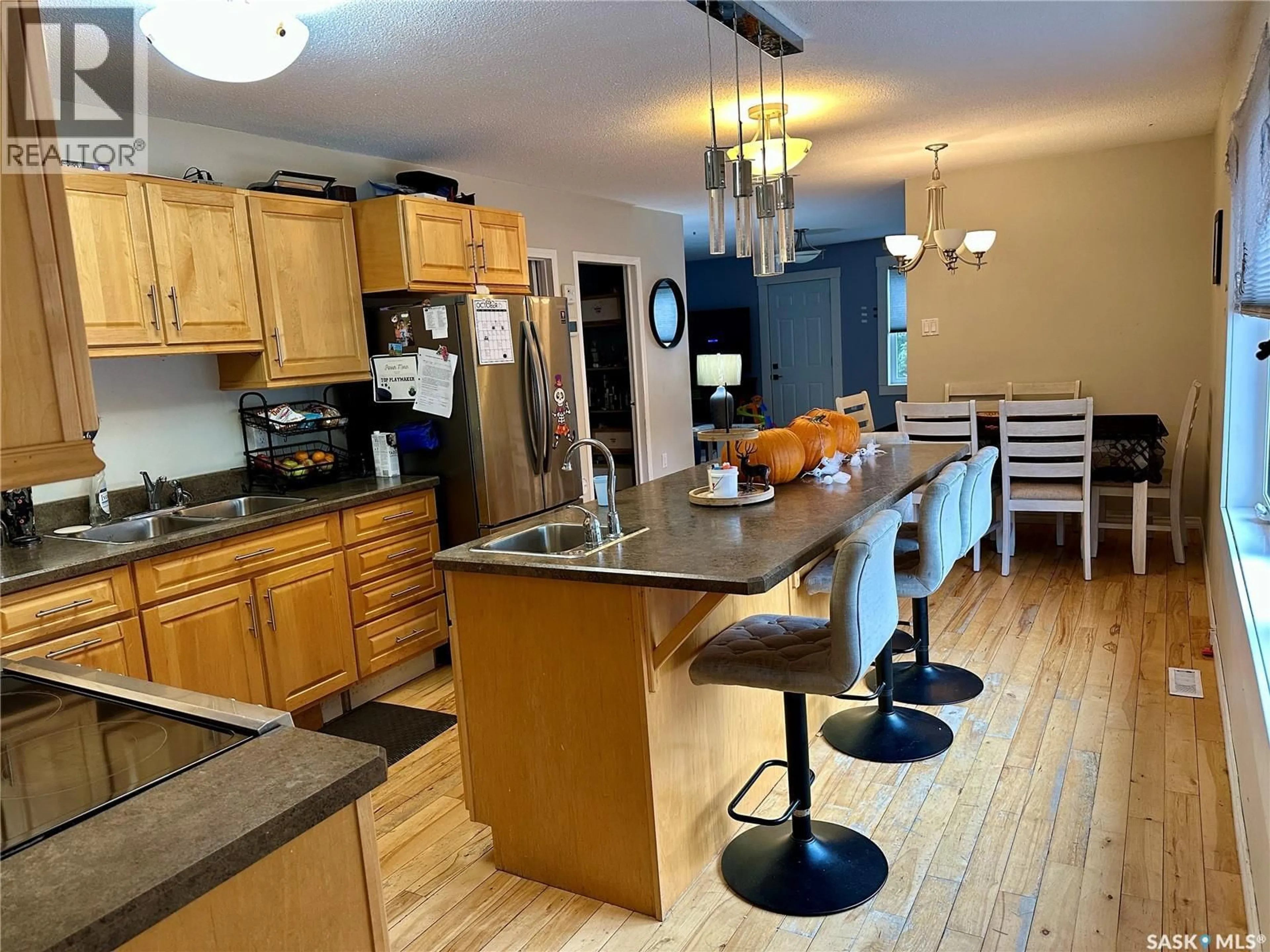 Open concept kitchen, wood/laminate floor for 524 GIBSON STREET, La Ronge Saskatchewan S0J1L0