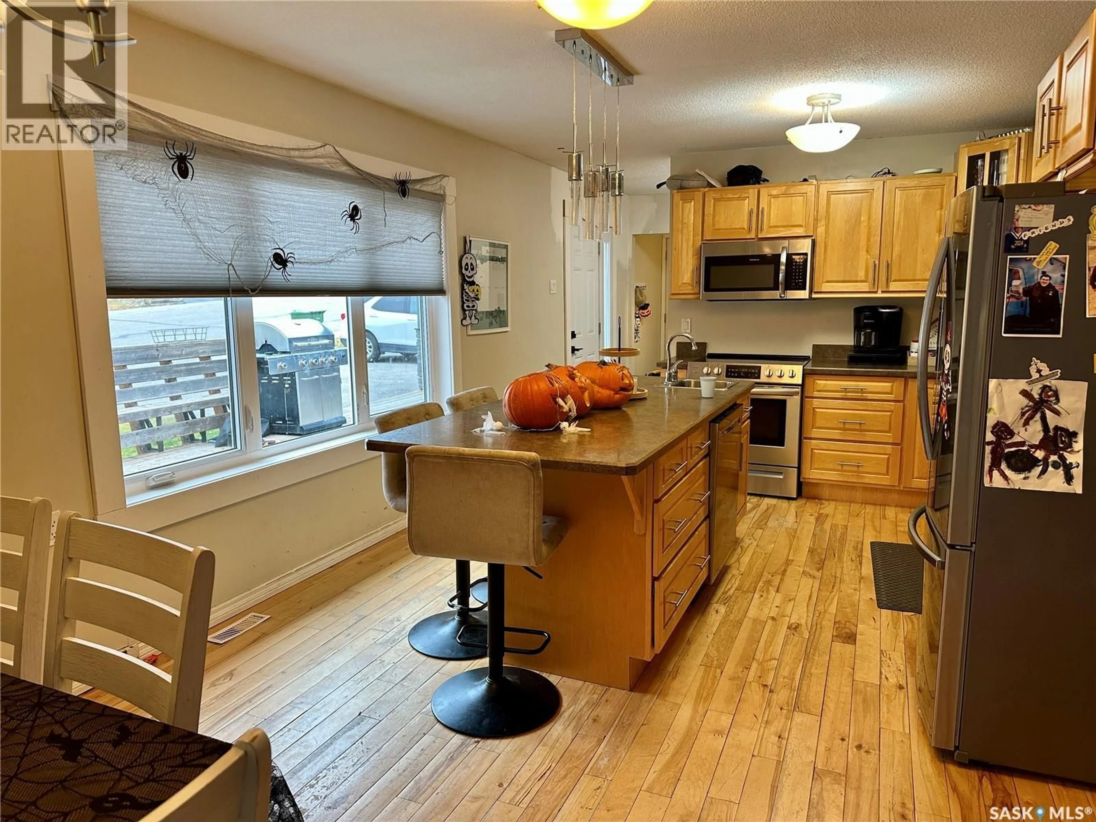 Open concept kitchen, wood/laminate floor for 524 GIBSON STREET, La Ronge Saskatchewan S0J1L0