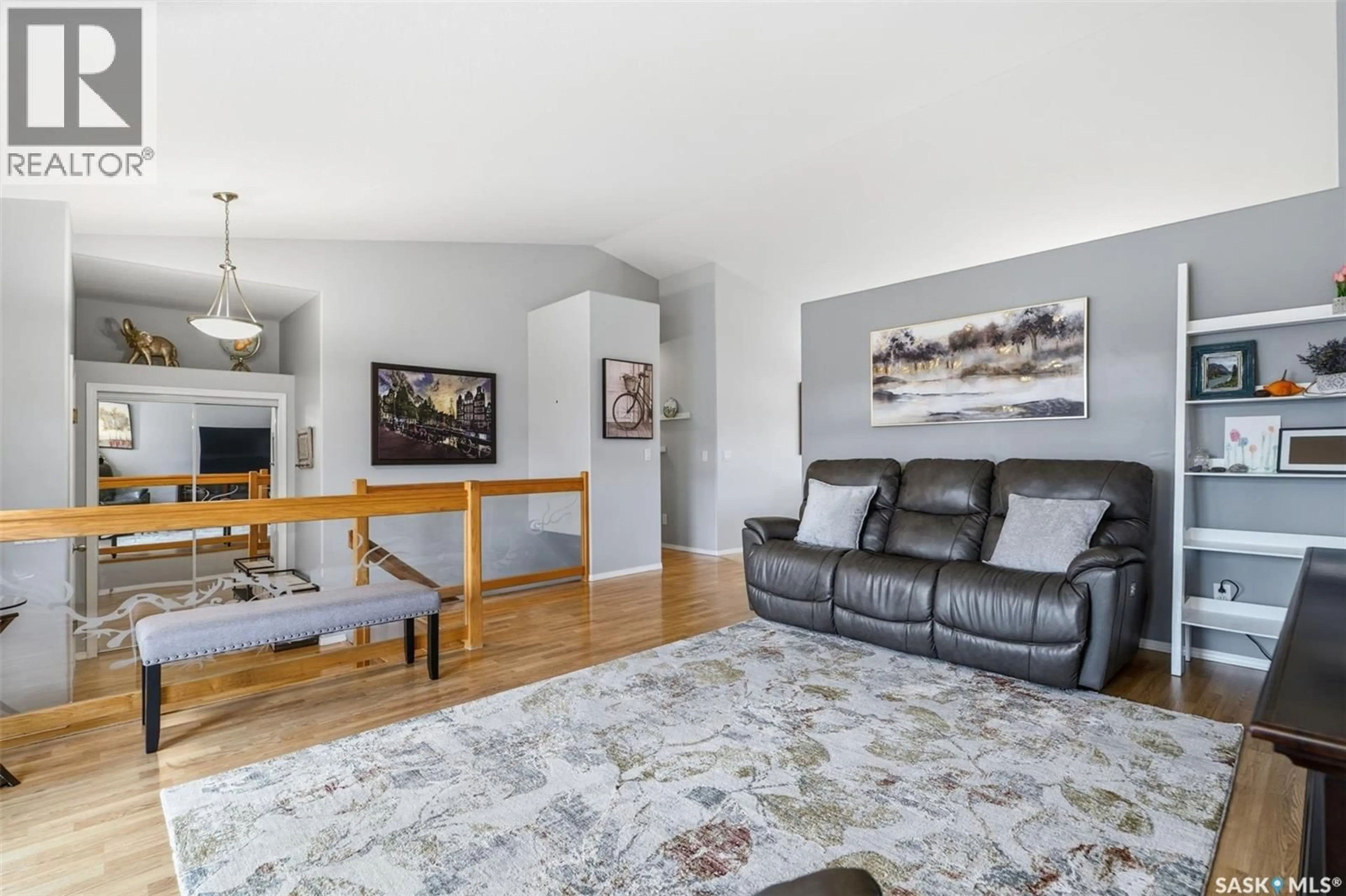 Living room with furniture, wood/laminate floor for 107 CARR CRESCENT, Saskatoon Saskatchewan S7S1M3