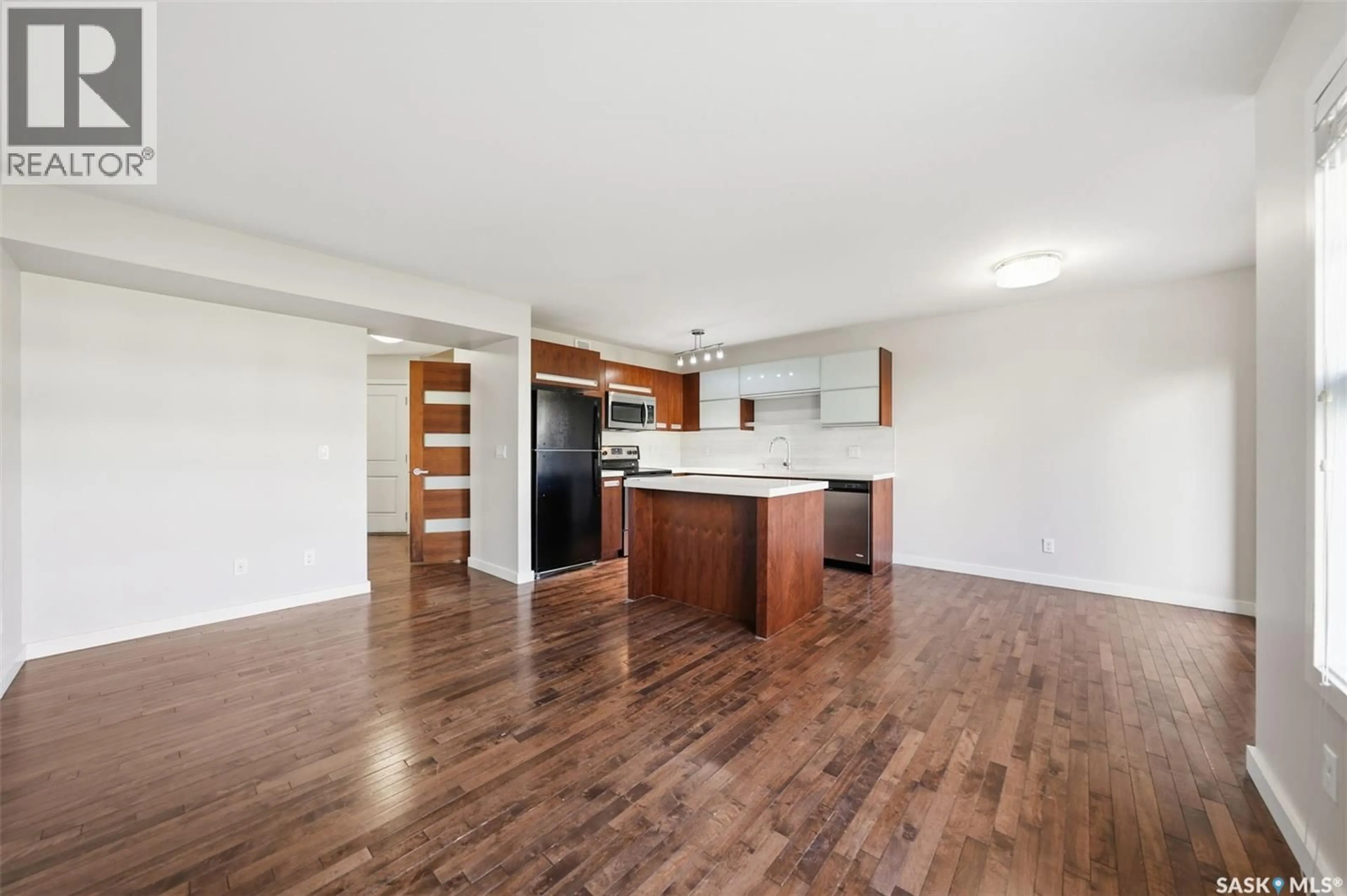 Open concept kitchen, wood/laminate floor for 408 1303 PATON CRESCENT, Saskatoon Saskatchewan S7W0B8