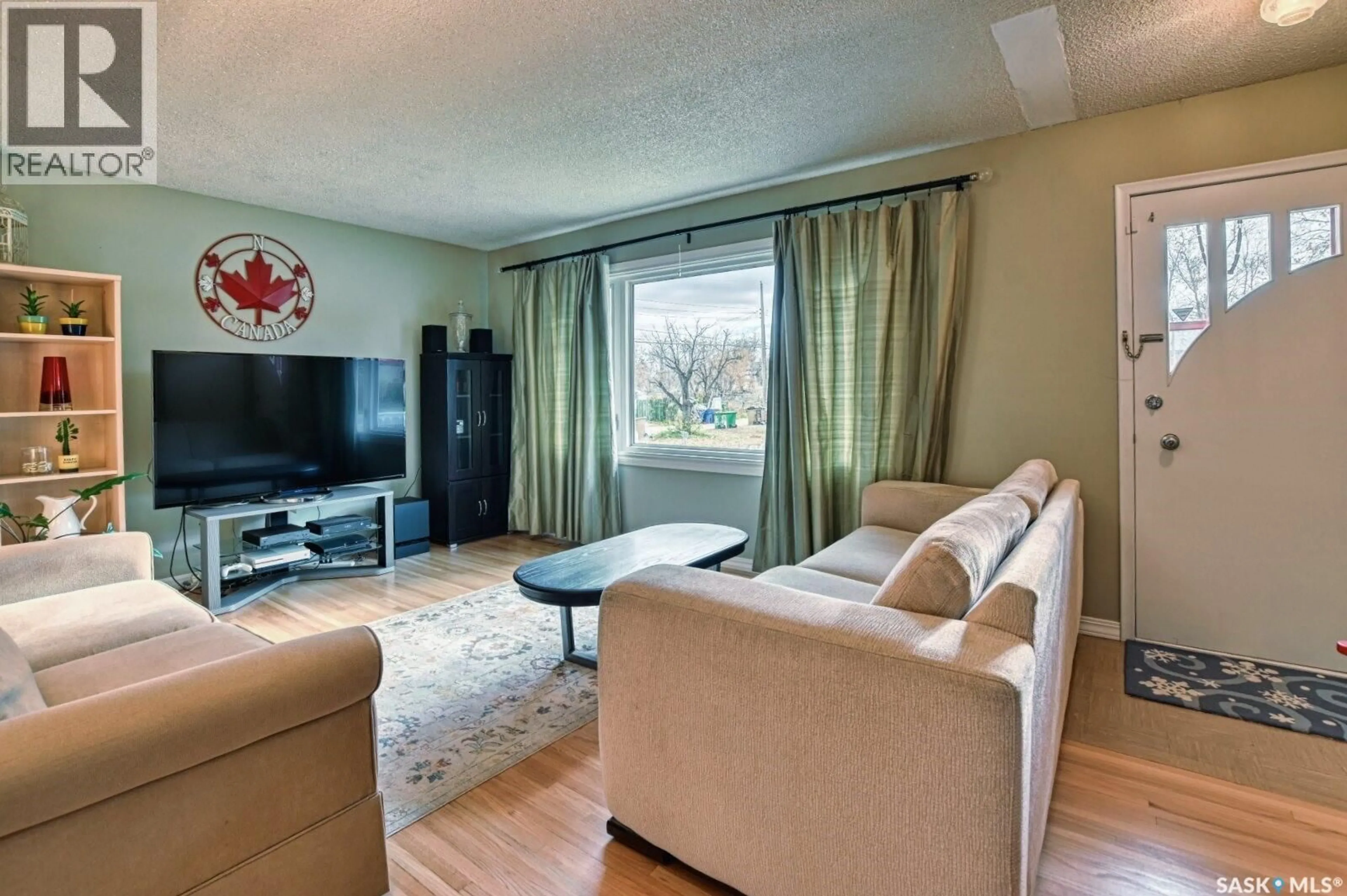 Living room with furniture, wood/laminate floor for 3030 2ND AVENUE, Regina Saskatchewan S4T0A8