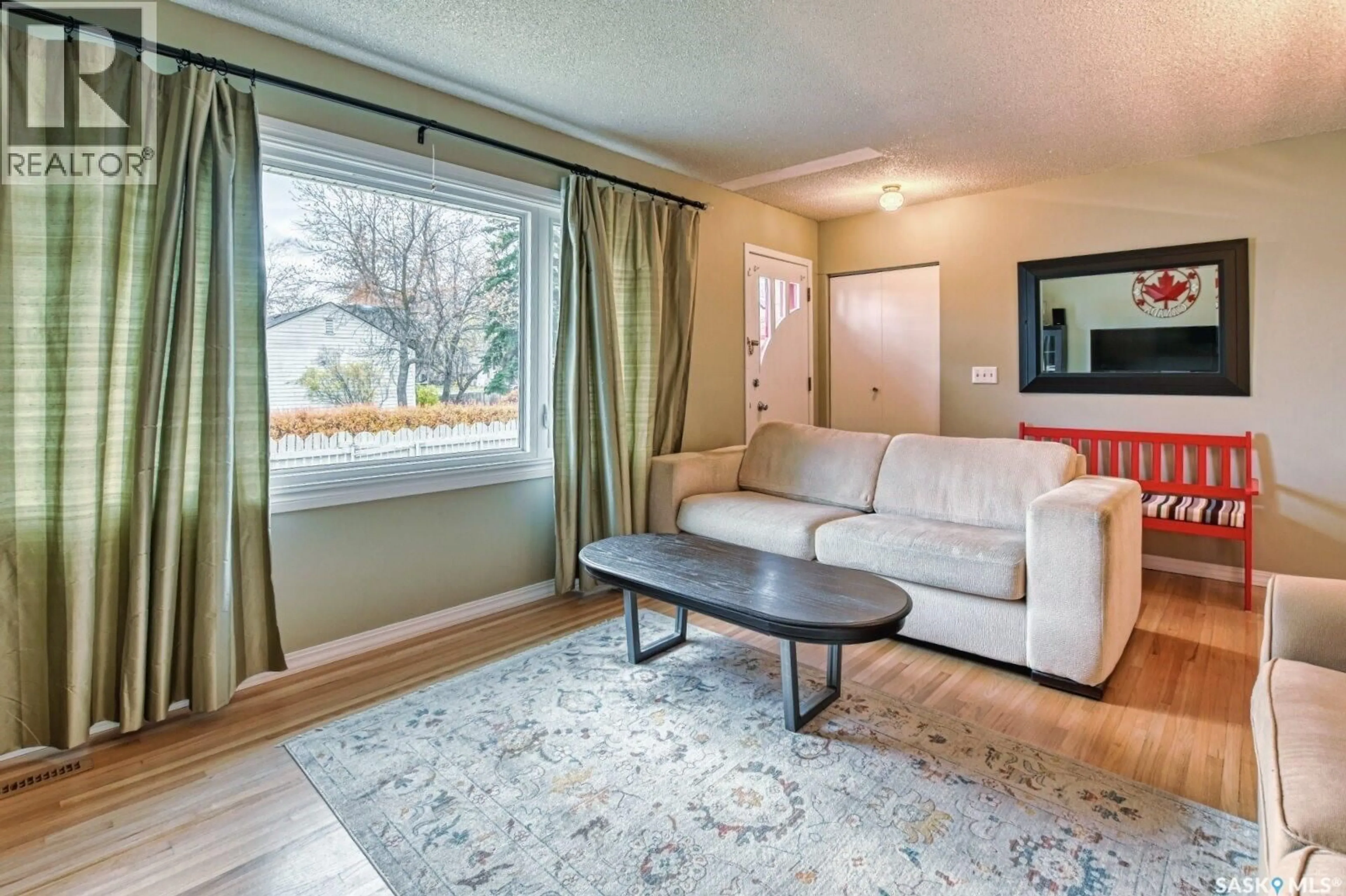 Living room with furniture, wood/laminate floor for 3030 2ND AVENUE, Regina Saskatchewan S4T0A8