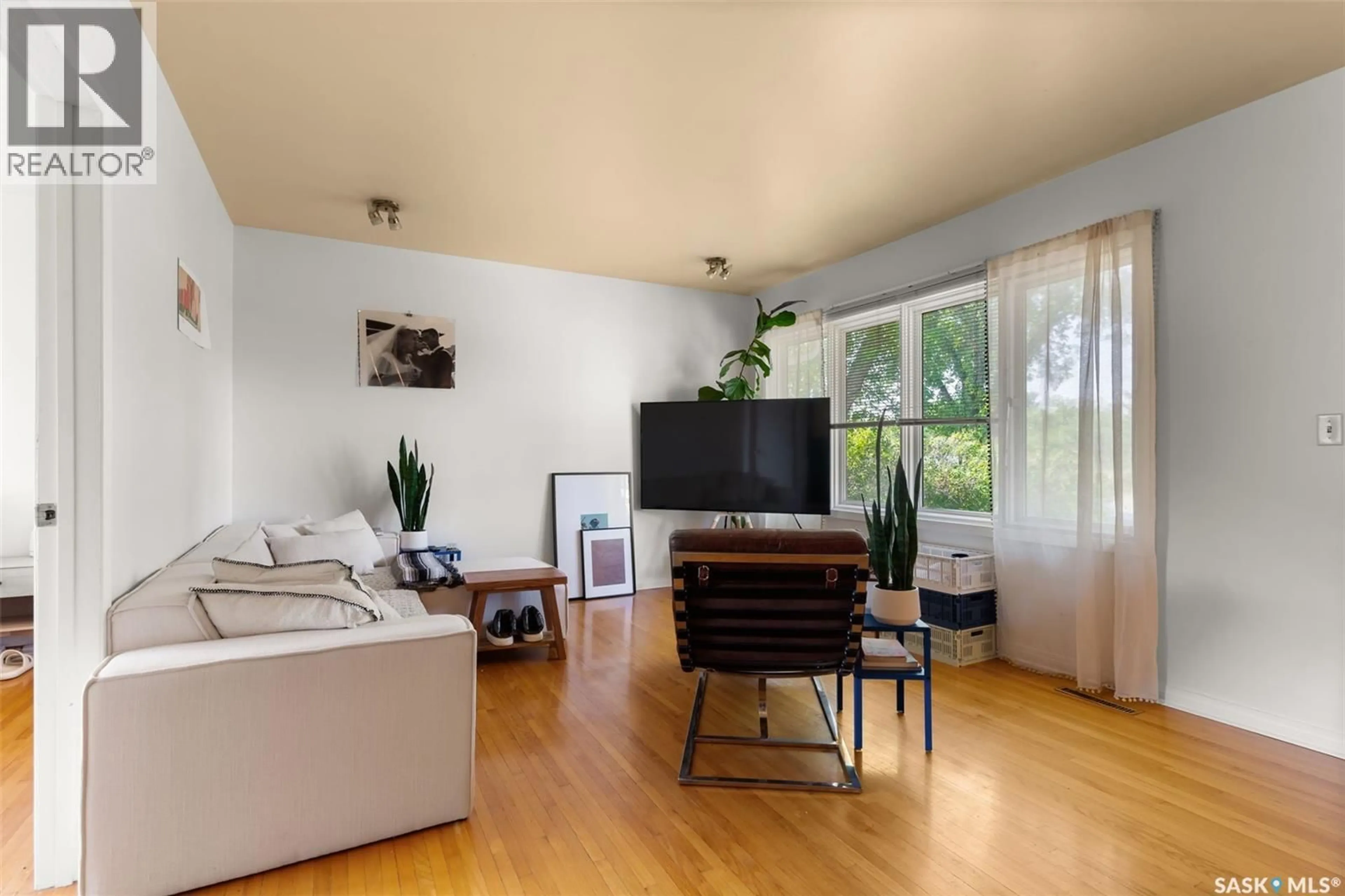 Living room with furniture, wood/laminate floor for 3819 GARNET STREET, Regina Saskatchewan S4S2K5