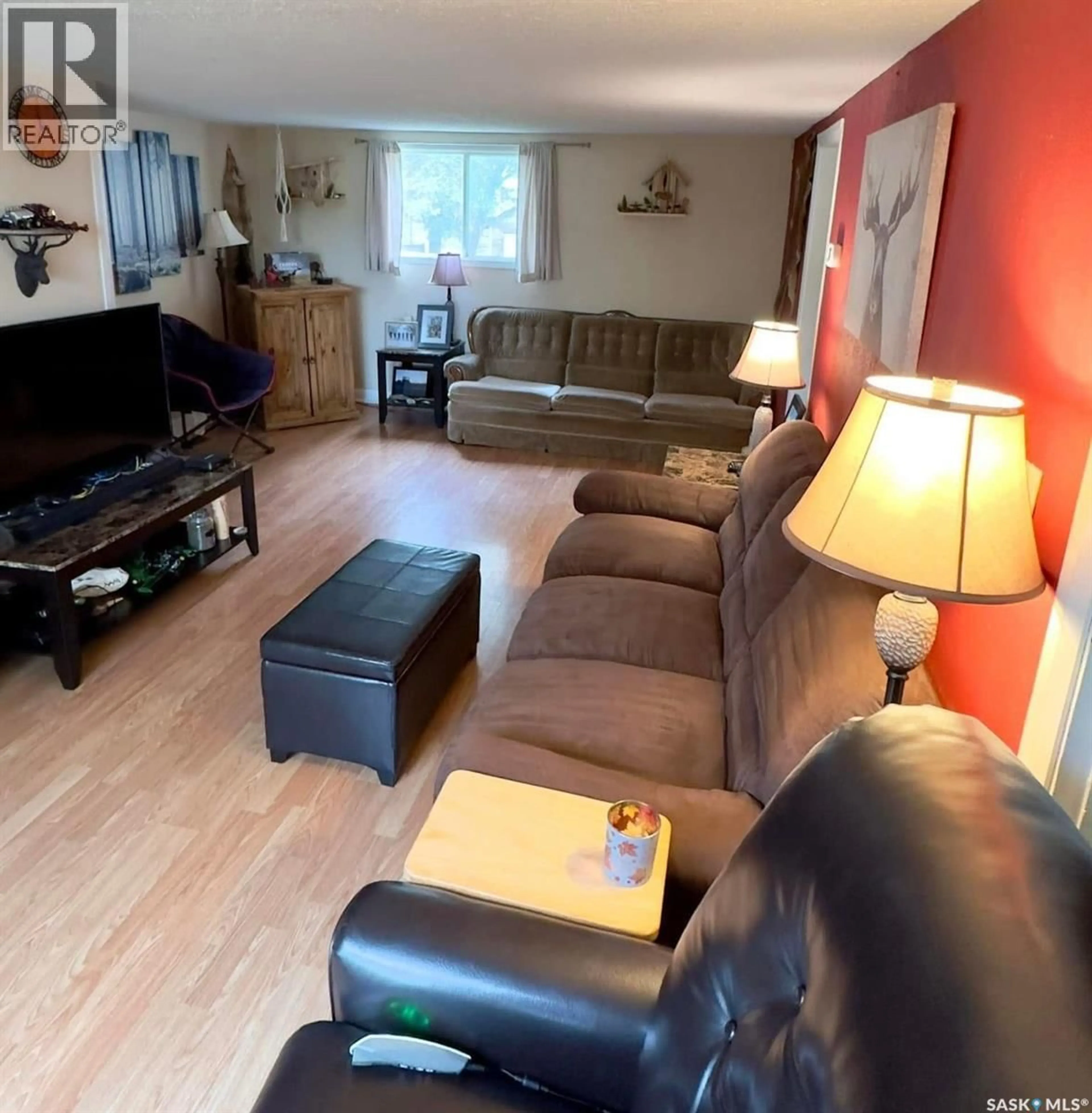 Living room with furniture, wood/laminate floor for 106 3RD AVENUE, Mossbank Saskatchewan S0H3G0