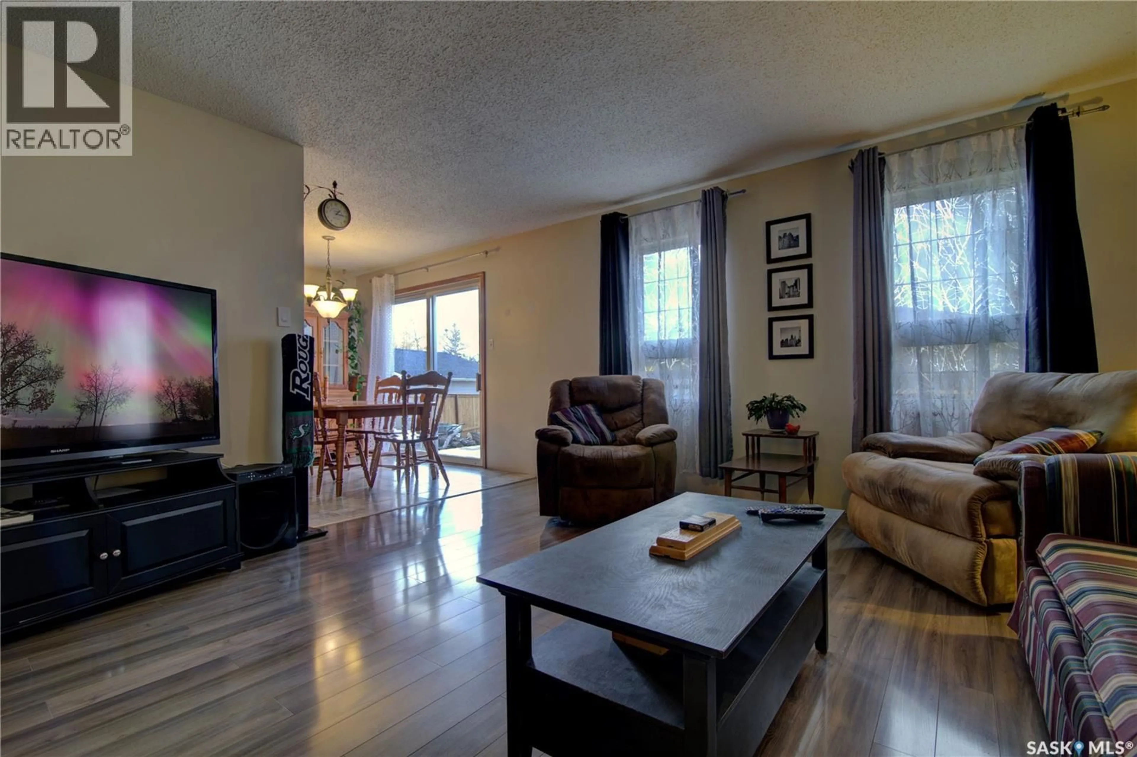 Living room with furniture, wood/laminate floor for 87 CARTER CRESCENT, Regina Saskatchewan S4X2C8