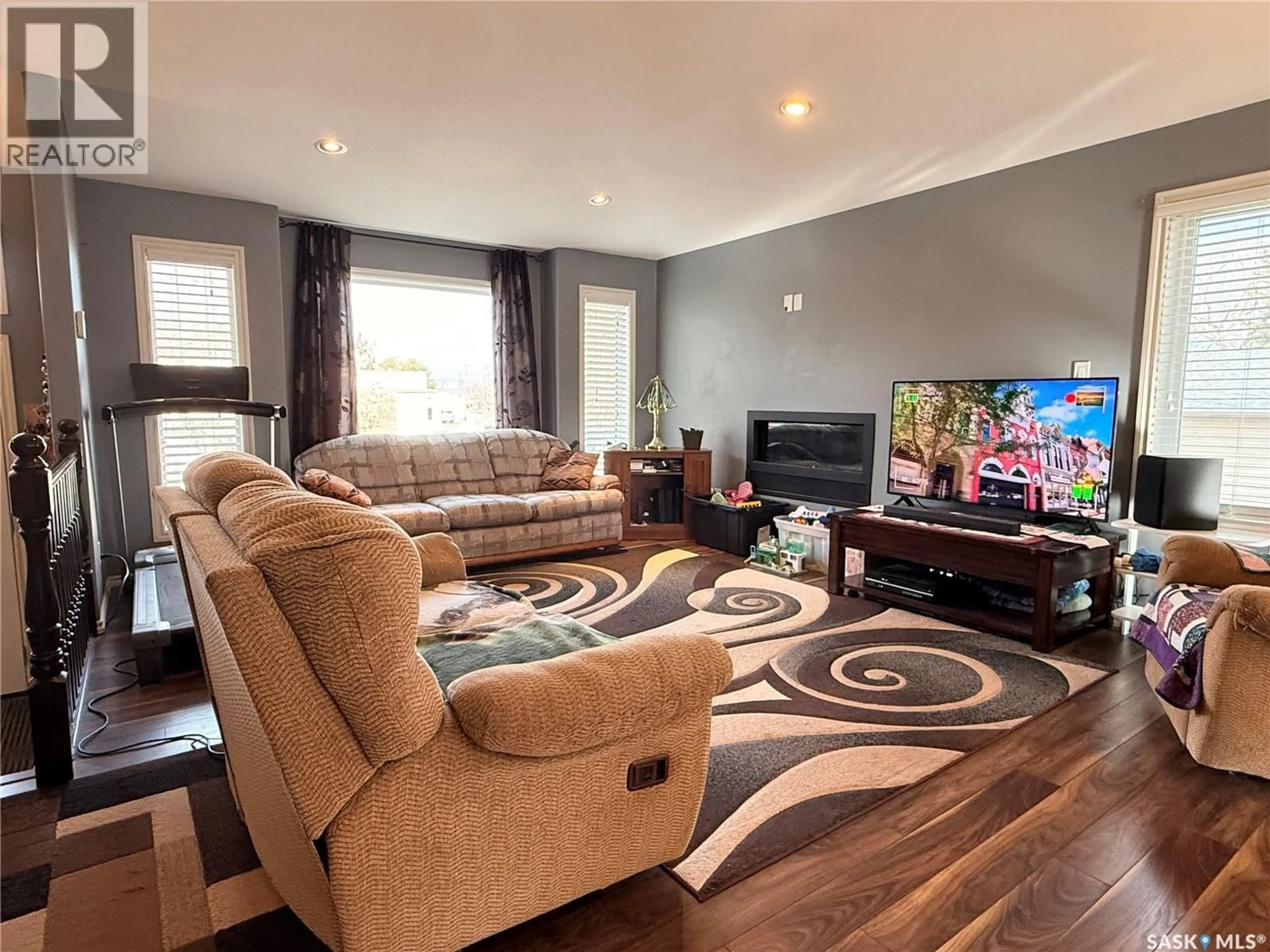 Living room with furniture, wood/laminate floor for 119 MARTIN STREET, Sedley Saskatchewan S0G4K0