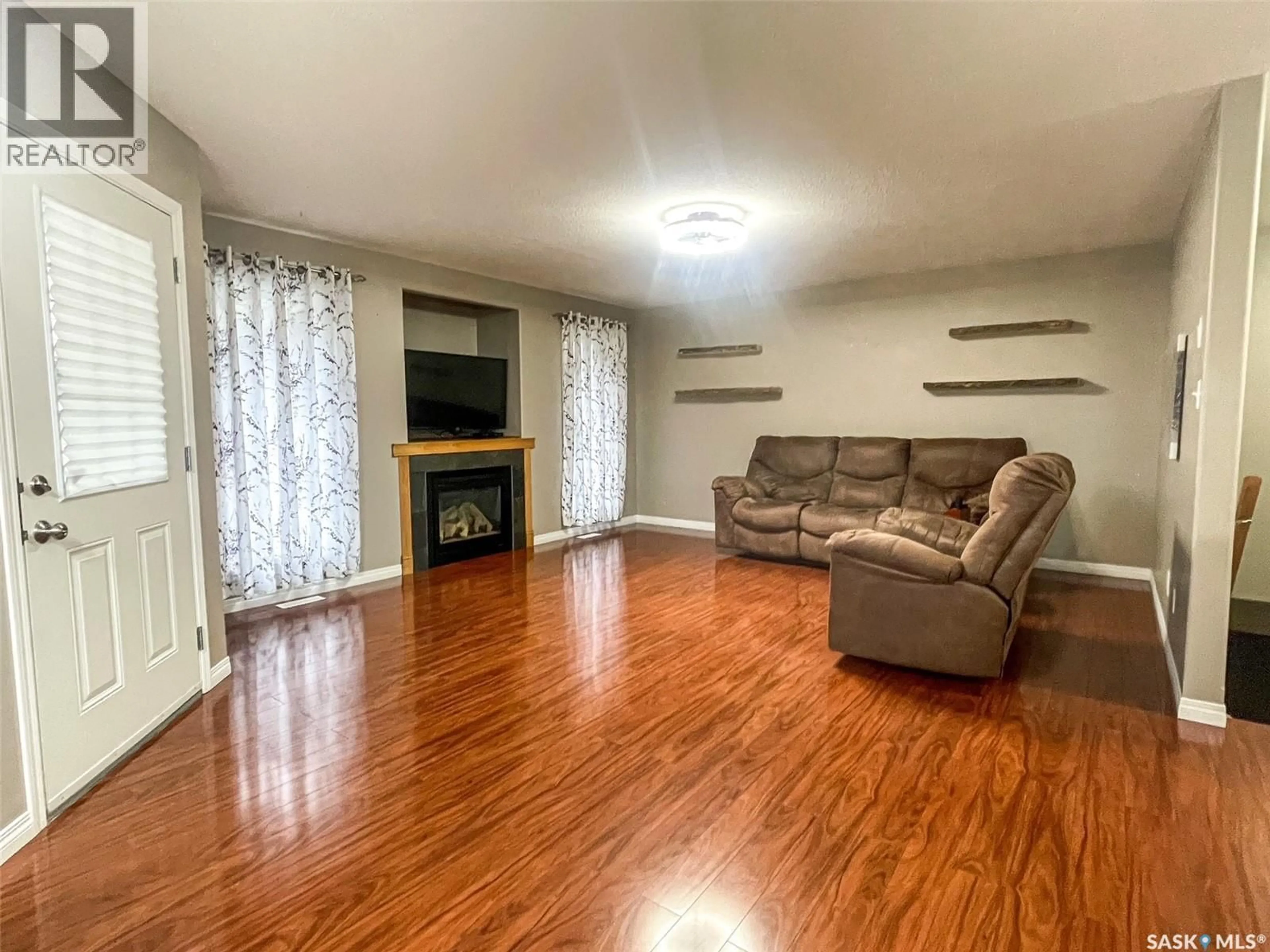 Living room with furniture, wood/laminate floor for 7 FAIRWAY COURT, Meadow Lake Saskatchewan S9X1Z9