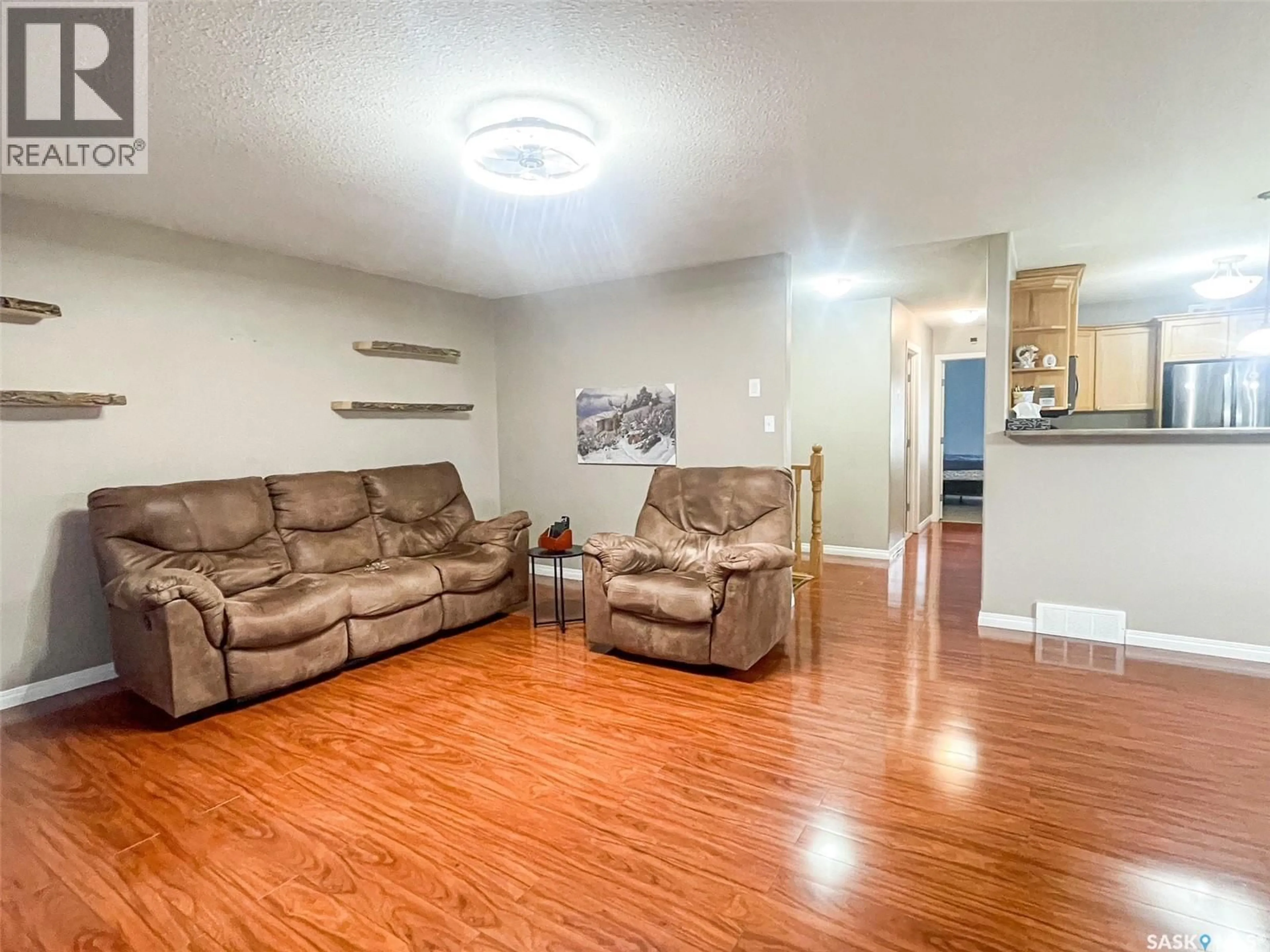 Living room with furniture, wood/laminate floor for 7 FAIRWAY COURT, Meadow Lake Saskatchewan S9X1Z9