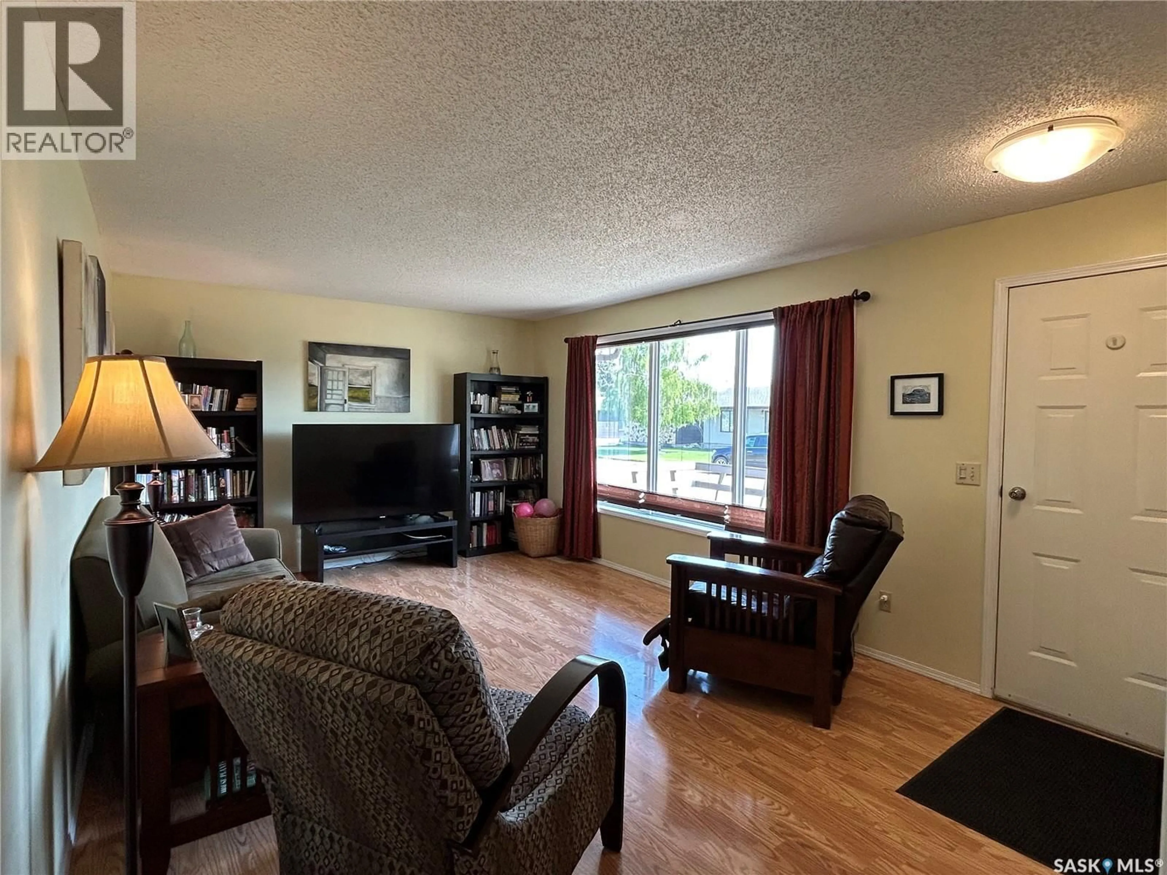 Living room with furniture, wood/laminate floor for 5 MAIN CRESCENT, Muenster Saskatchewan S0K2Y0