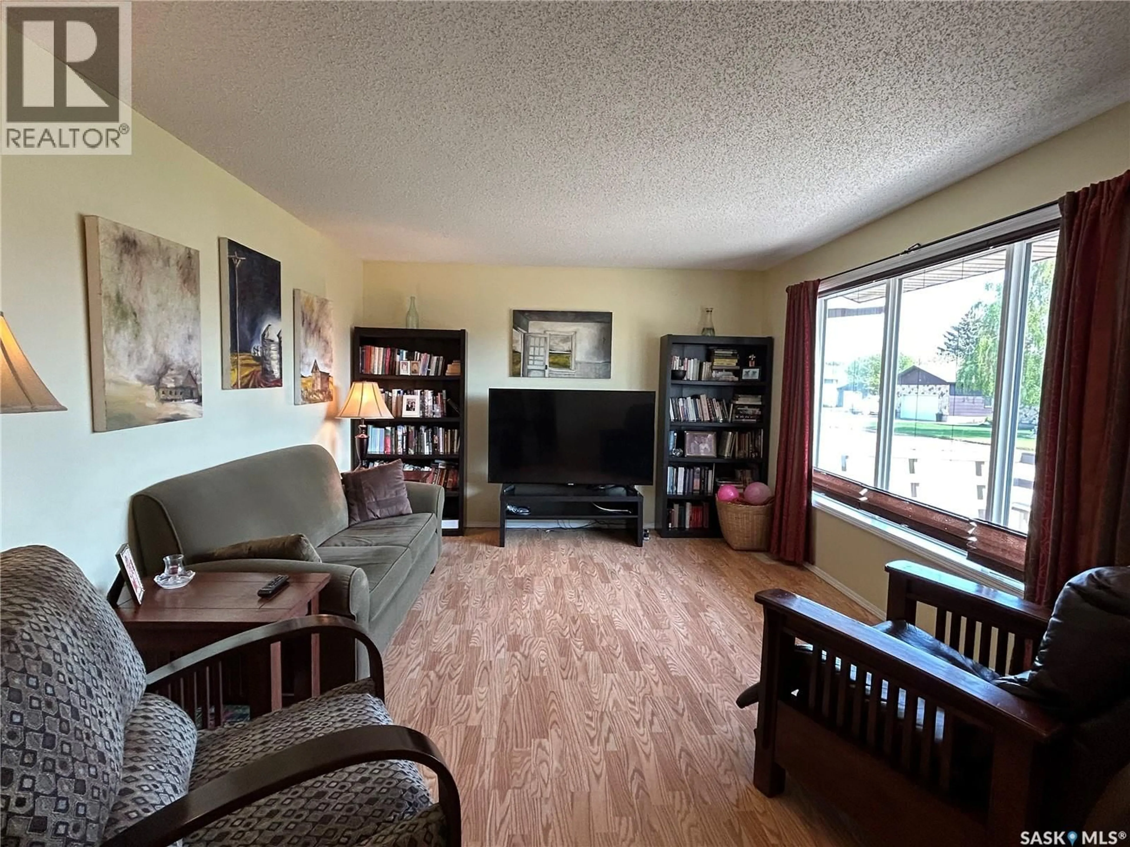 Living room with furniture, wood/laminate floor for 5 MAIN CRESCENT, Muenster Saskatchewan S0K2Y0