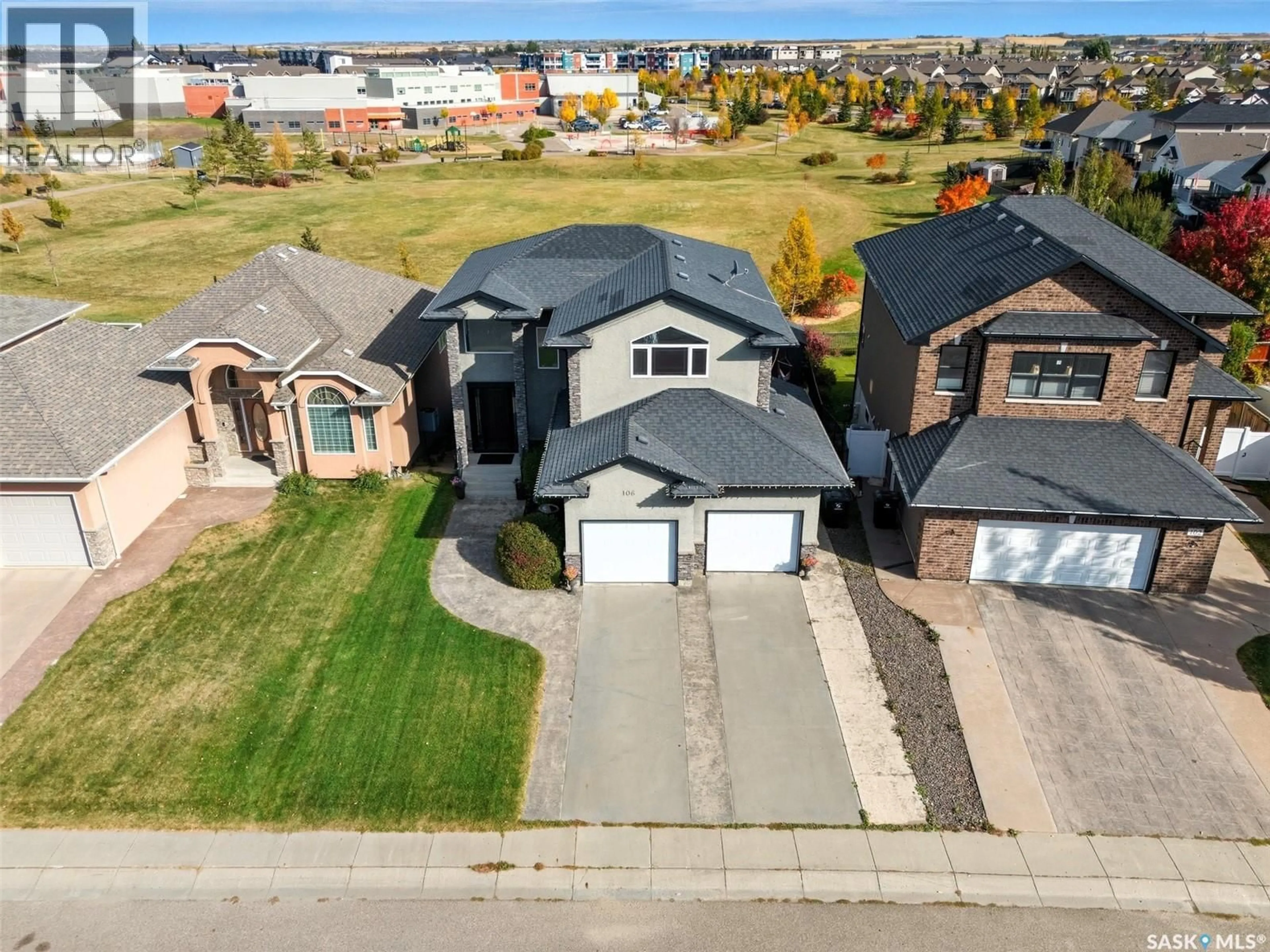 A pic from outside/outdoor area/front of a property/back of a property/a pic from drone, street for 106 THODE AVENUE, Saskatoon Saskatchewan S7W1A1