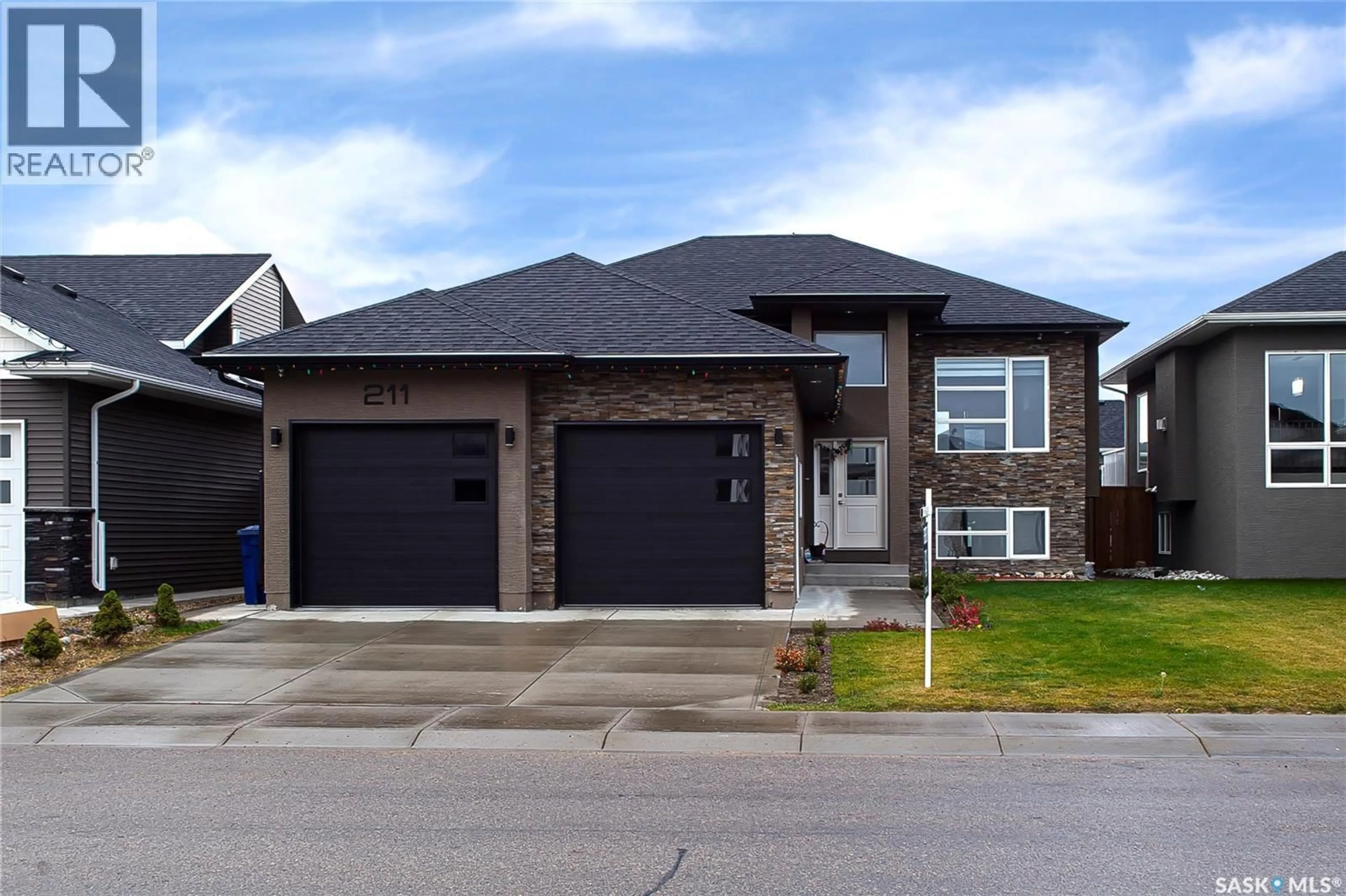 Home with brick exterior material, street for 211 SETTLER CRESCENT, Warman Saskatchewan S0K4S2