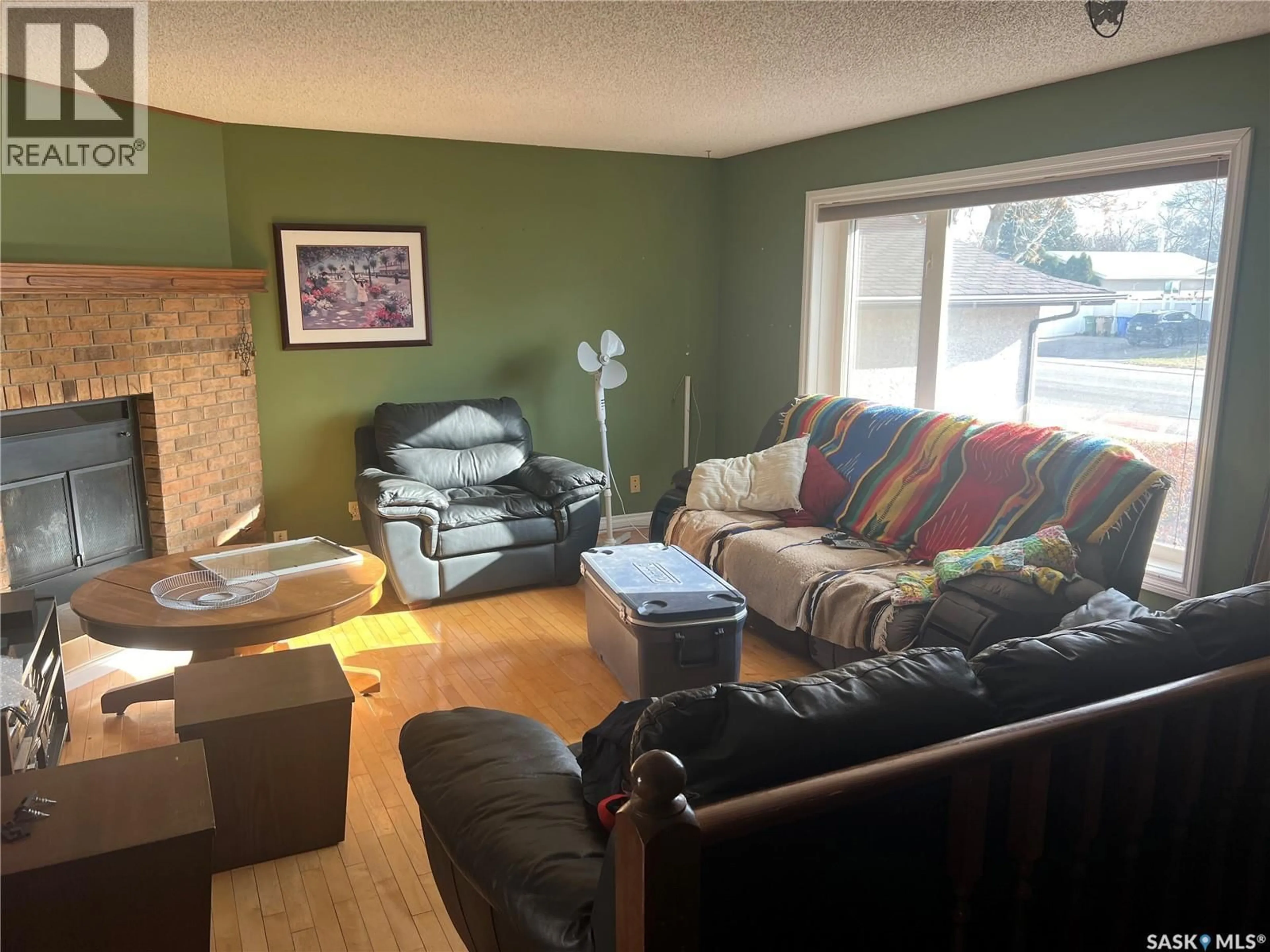 Living room with furniture, wood/laminate floor for 7212 1ST AVENUE, Regina Saskatchewan S4X3C4
