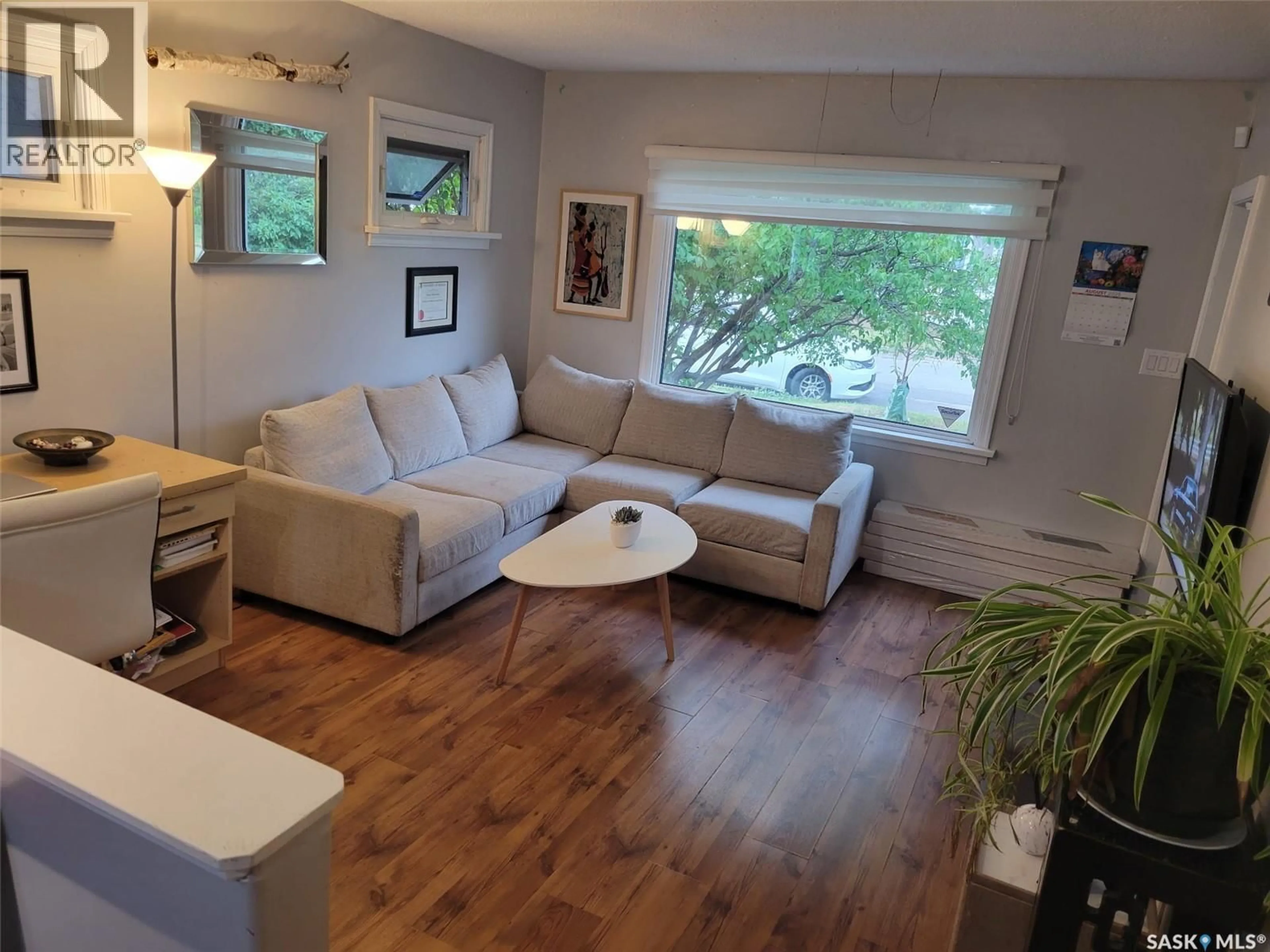 Living room with furniture, wood/laminate floor for 513 10TH STREET, Prince Albert Saskatchewan S6V0Z7