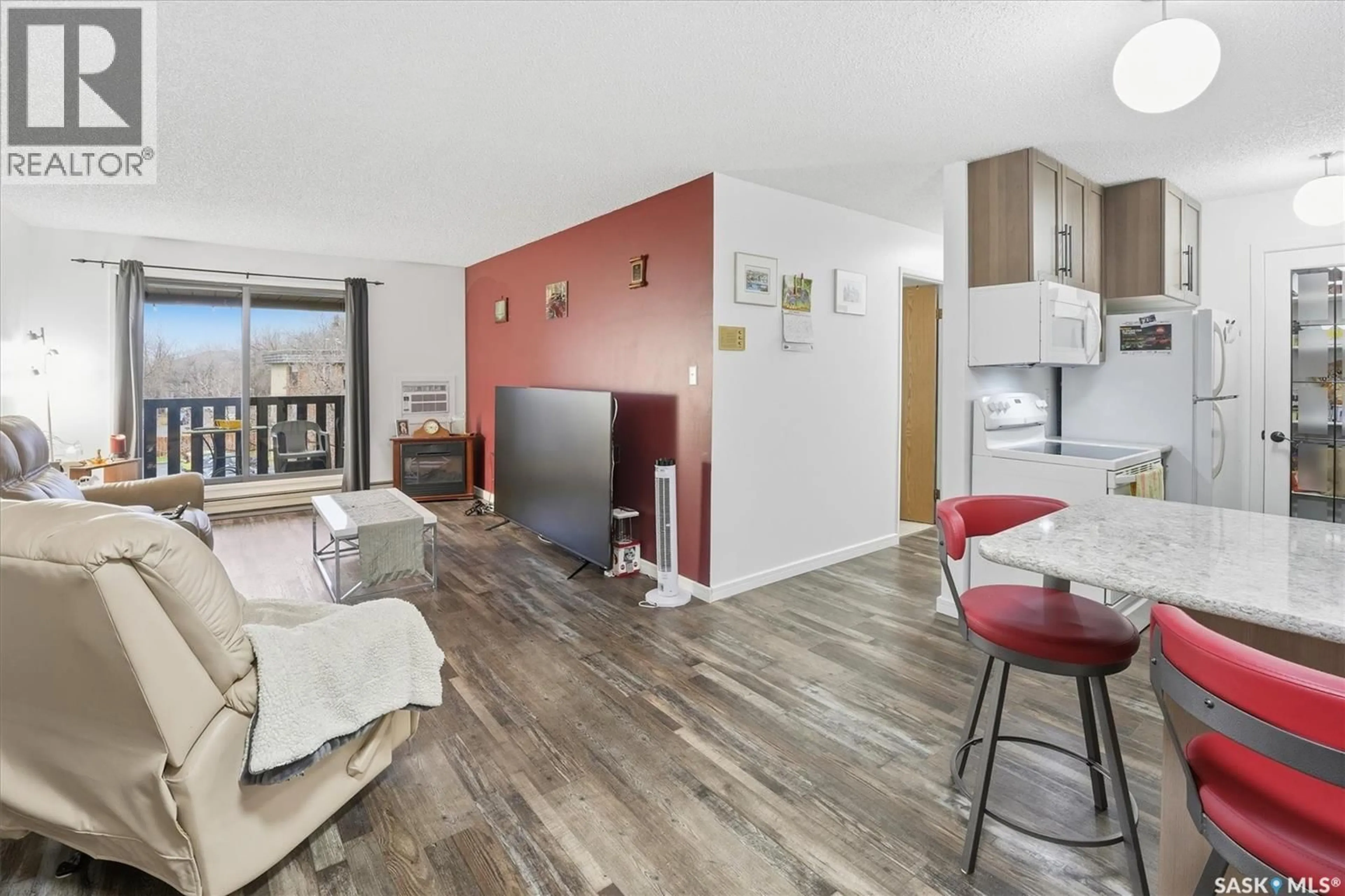 Living room with furniture, wood/laminate floor for 403 - 304 TAIT COURT, Saskatoon Saskatchewan S7H5L3