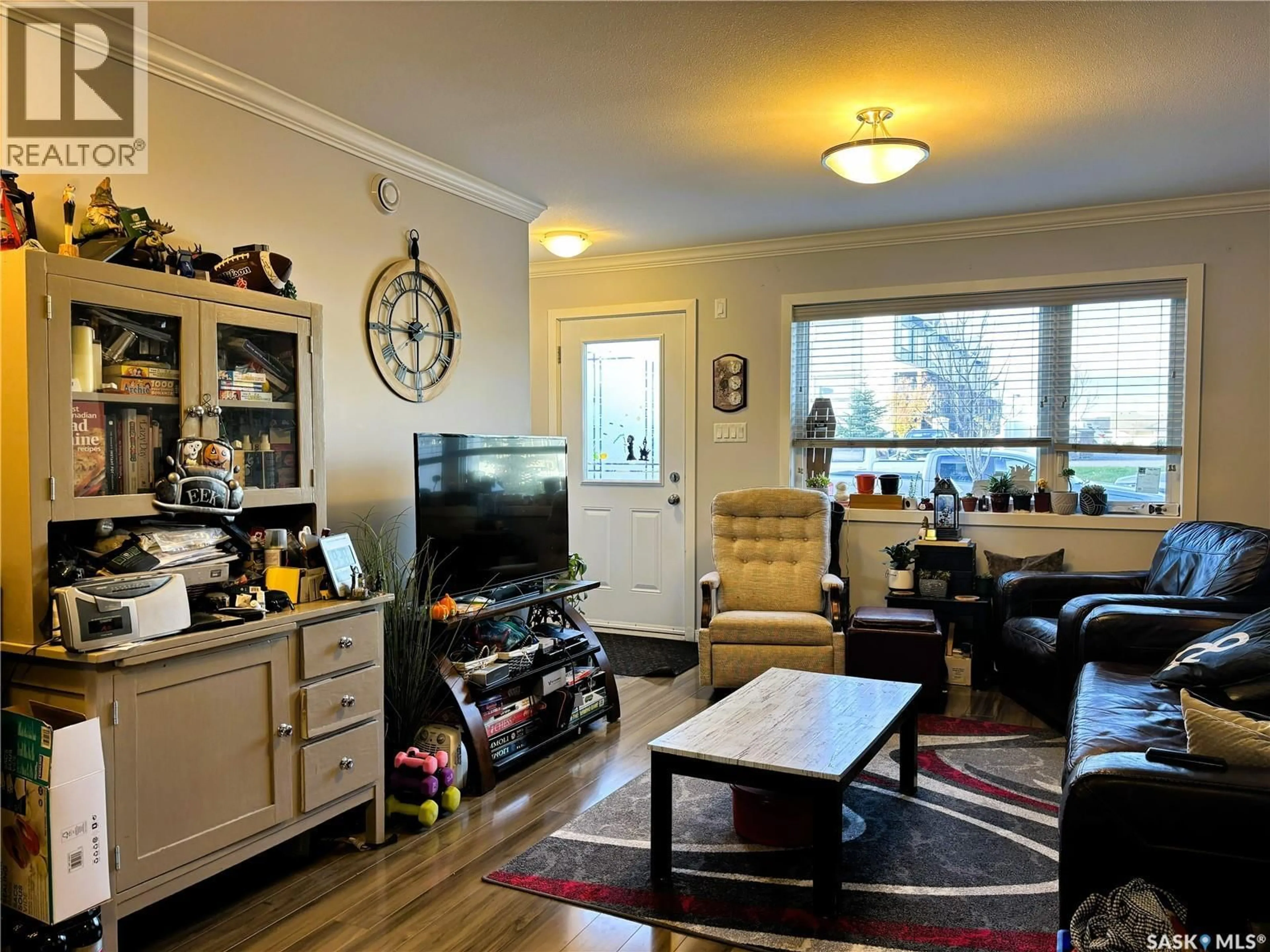 Living room with furniture, wood/laminate floor for 270 250 AKHTAR BEND, Saskatoon Saskatchewan S7W0W4