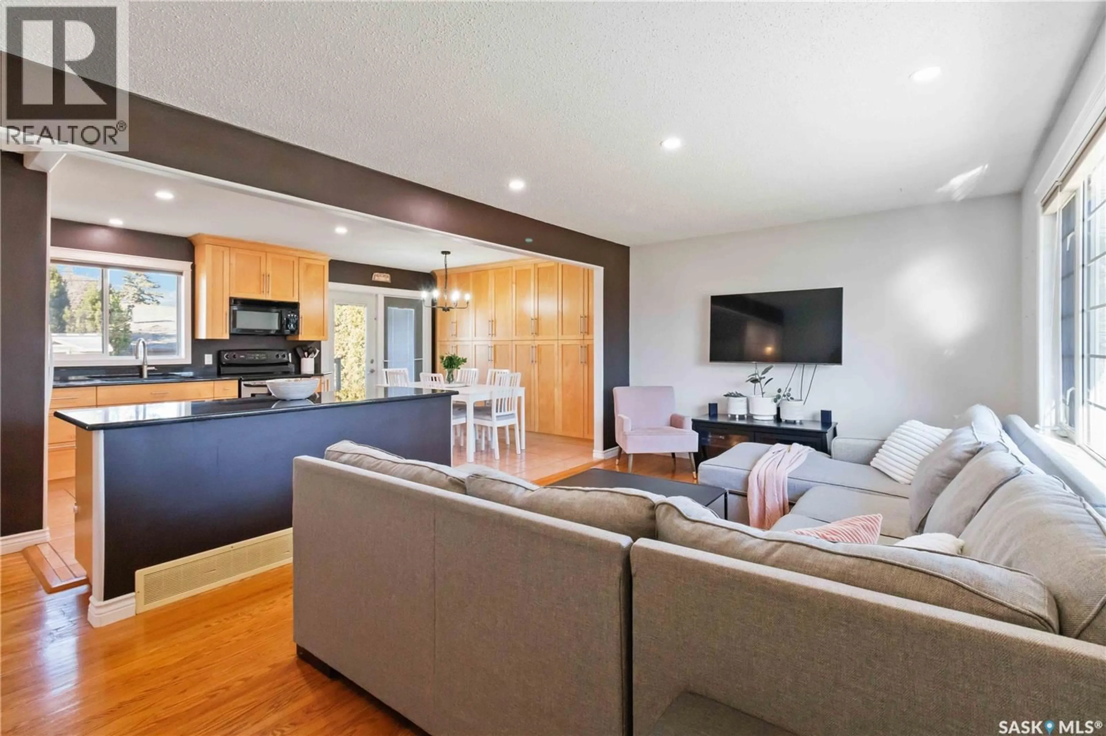 Living room with furniture, wood/laminate floor for 8 MACLEAN CRESCENT, Saskatoon Saskatchewan S7J2R7