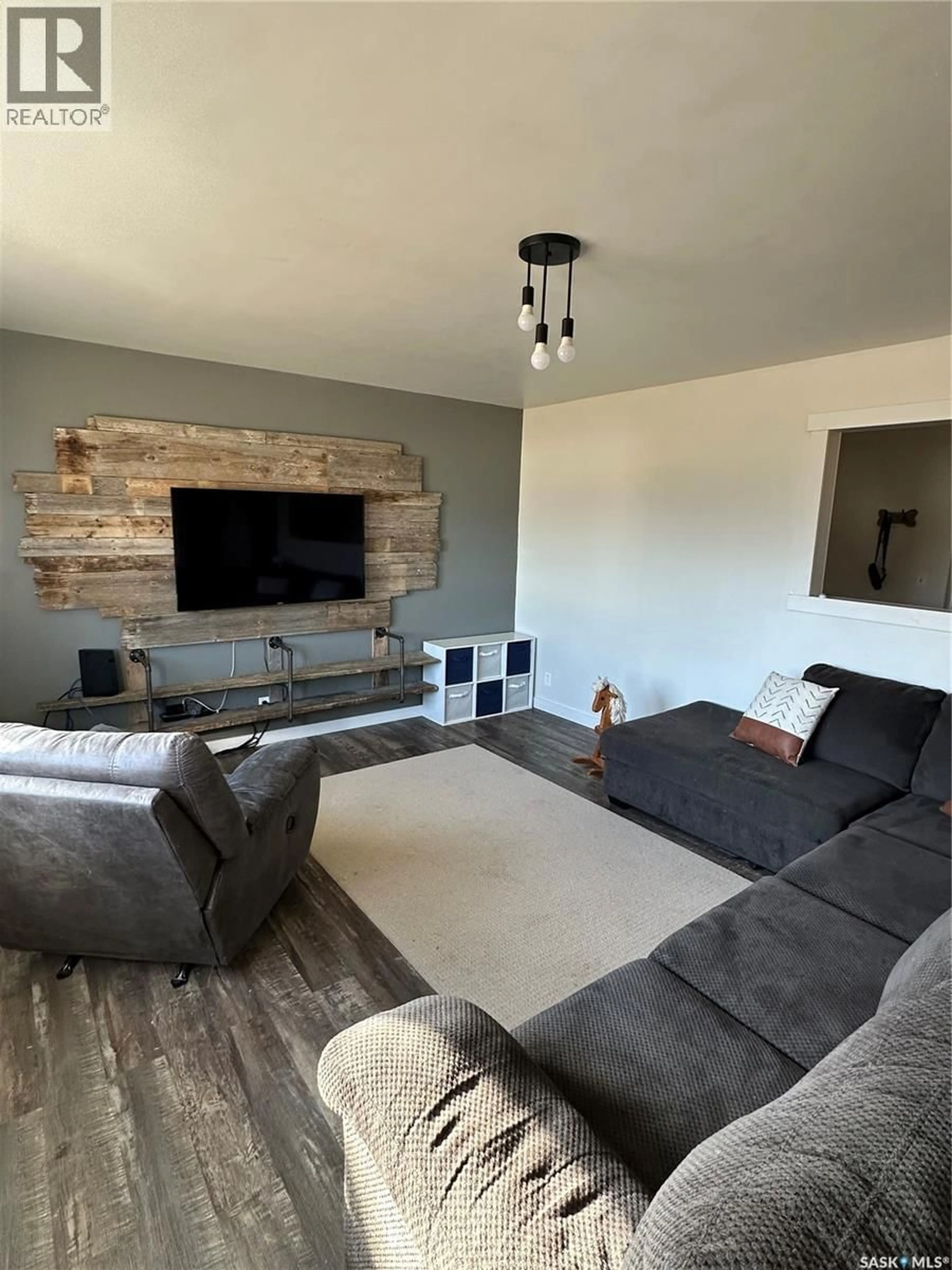 Living room with furniture, wood/laminate floor for 8368 HOWARD AVENUE, Gull Lake Saskatchewan S0N1A0