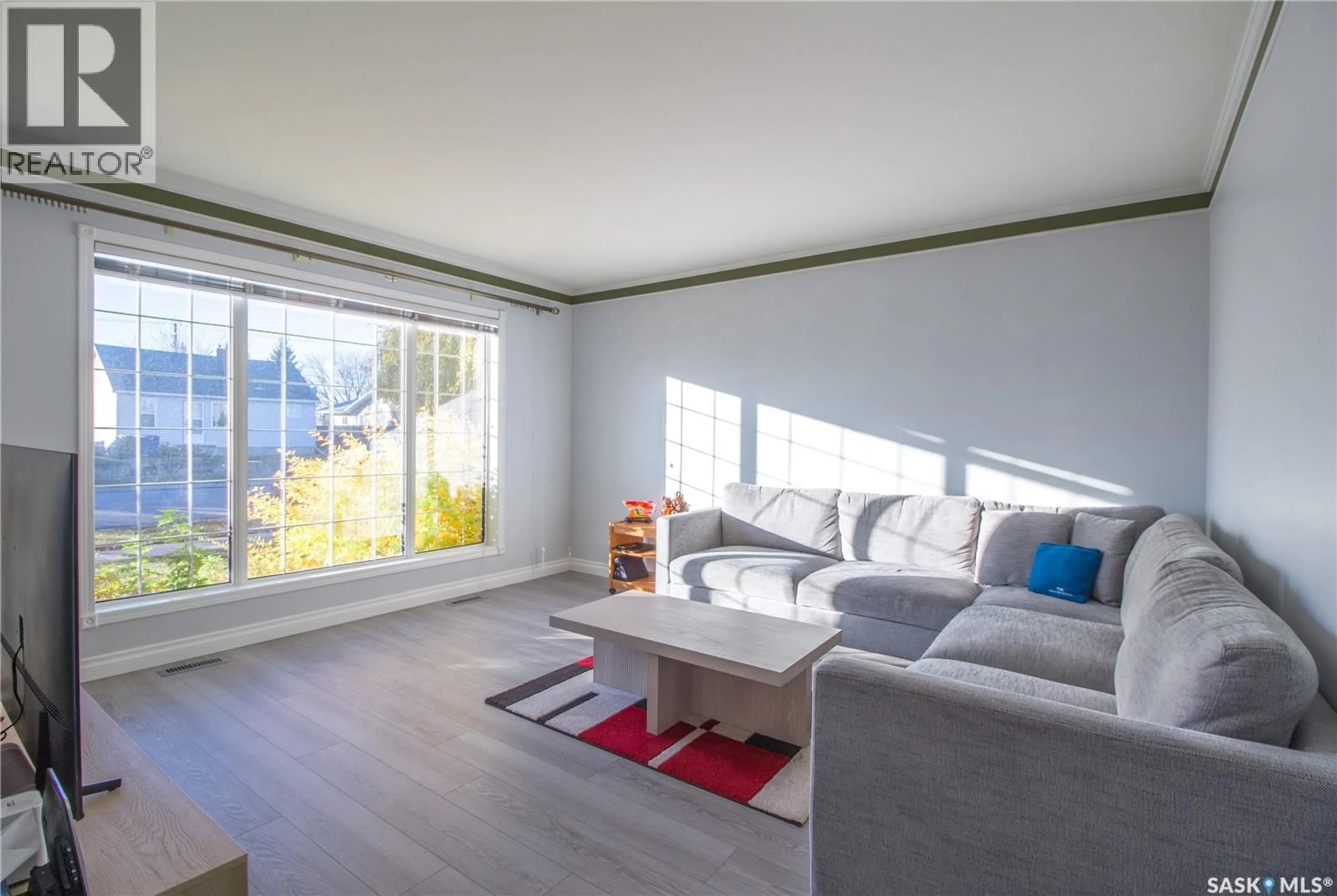 Living room with furniture, wood/laminate floor for 322 7TH STREET, Humboldt Saskatchewan S0K2A0