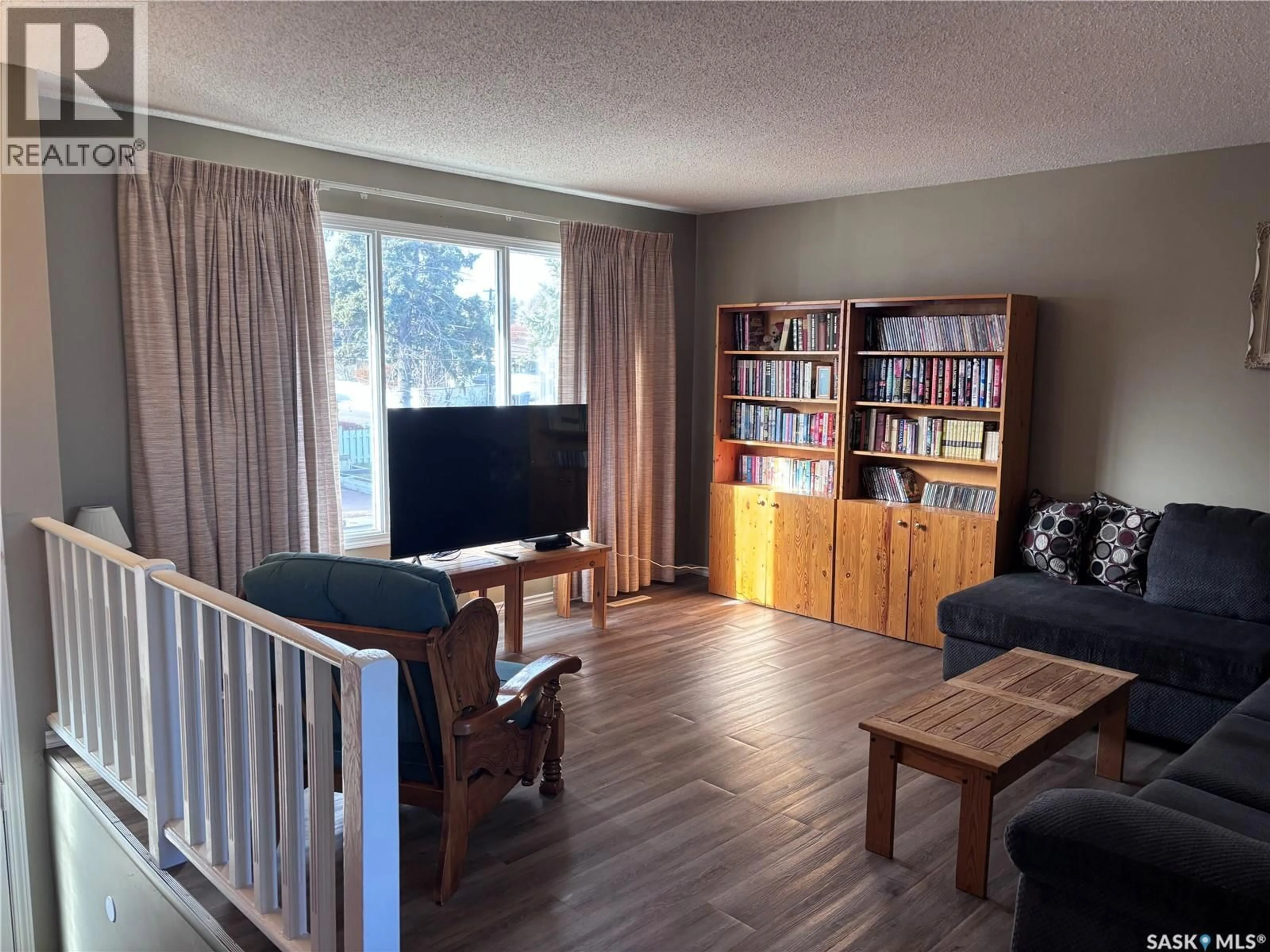 Living room with furniture, wood/laminate floor for 269 5TH AVENUE, Swift Current Saskatchewan S9H2L3