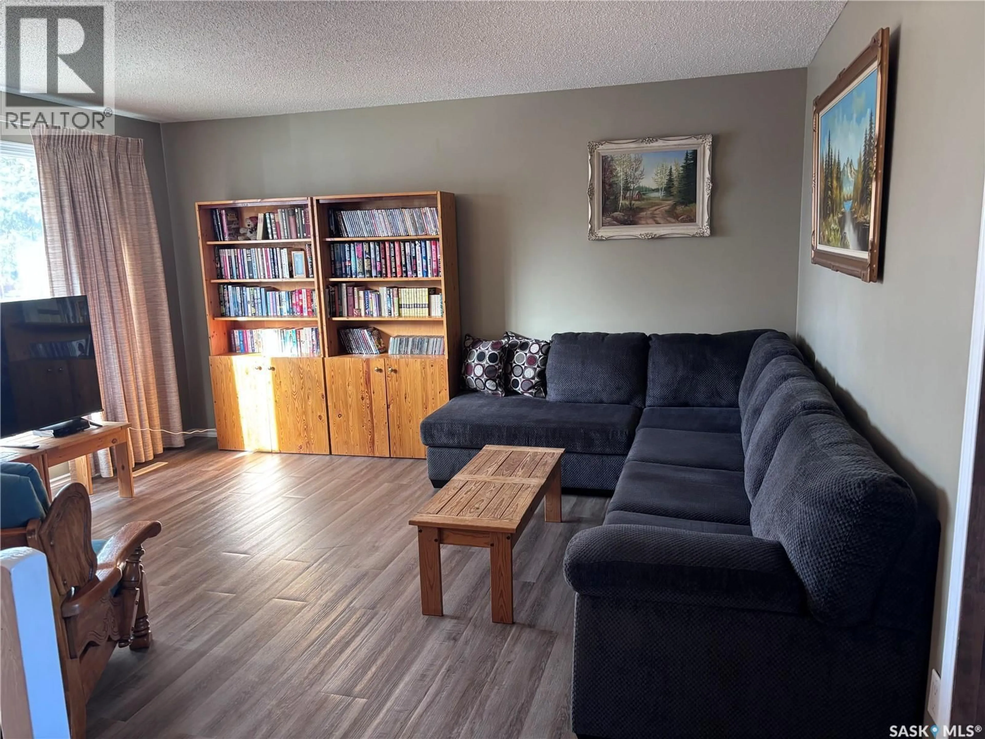 Living room with furniture, wood/laminate floor for 269 5TH AVENUE, Swift Current Saskatchewan S9H2L3