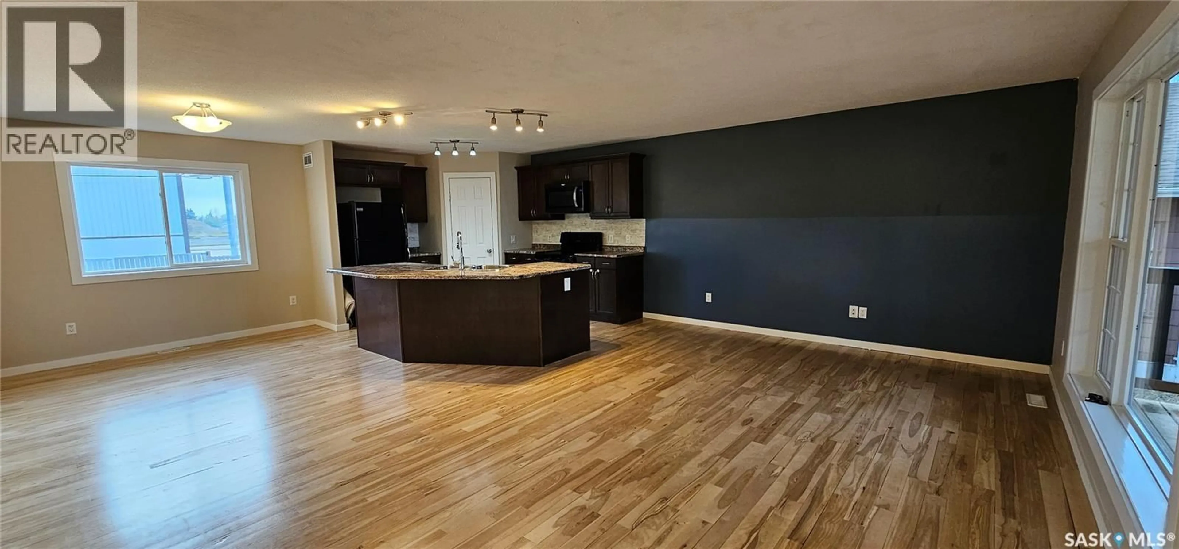 Open concept kitchen, wood/laminate floor for 317 BURROWS AVENUE, Melfort Saskatchewan S0E1A0