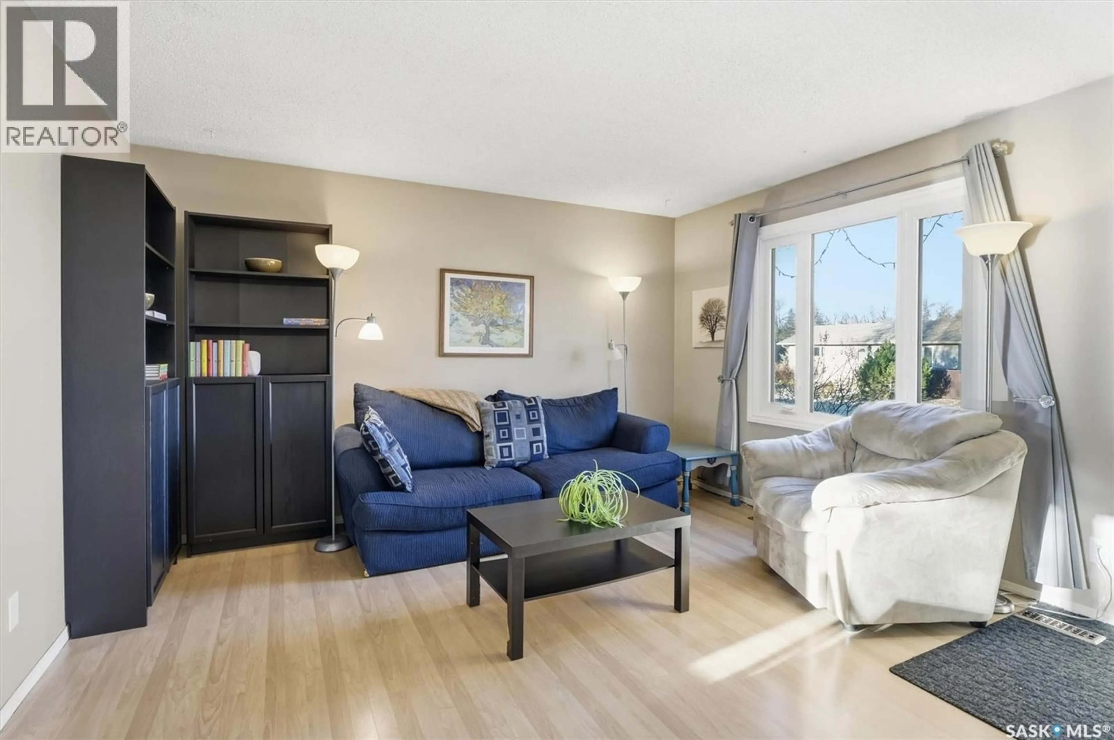 Living room with furniture, wood/laminate floor for 441 BROCK CRESCENT, Saskatoon Saskatchewan S7H4N3