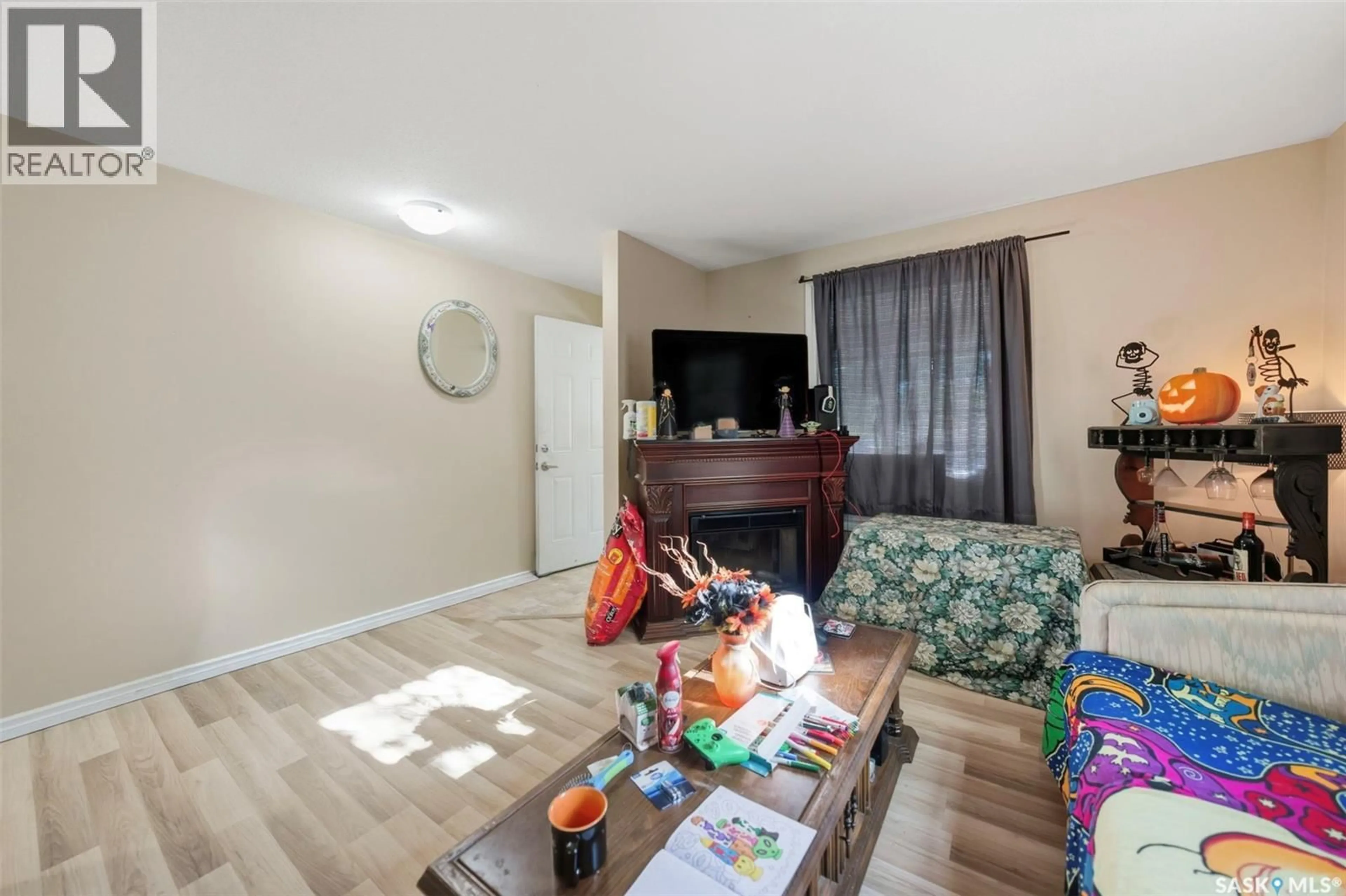 Living room with furniture, wood/laminate floor for 1121 108TH STREET, North Battleford Saskatchewan S9A2B1