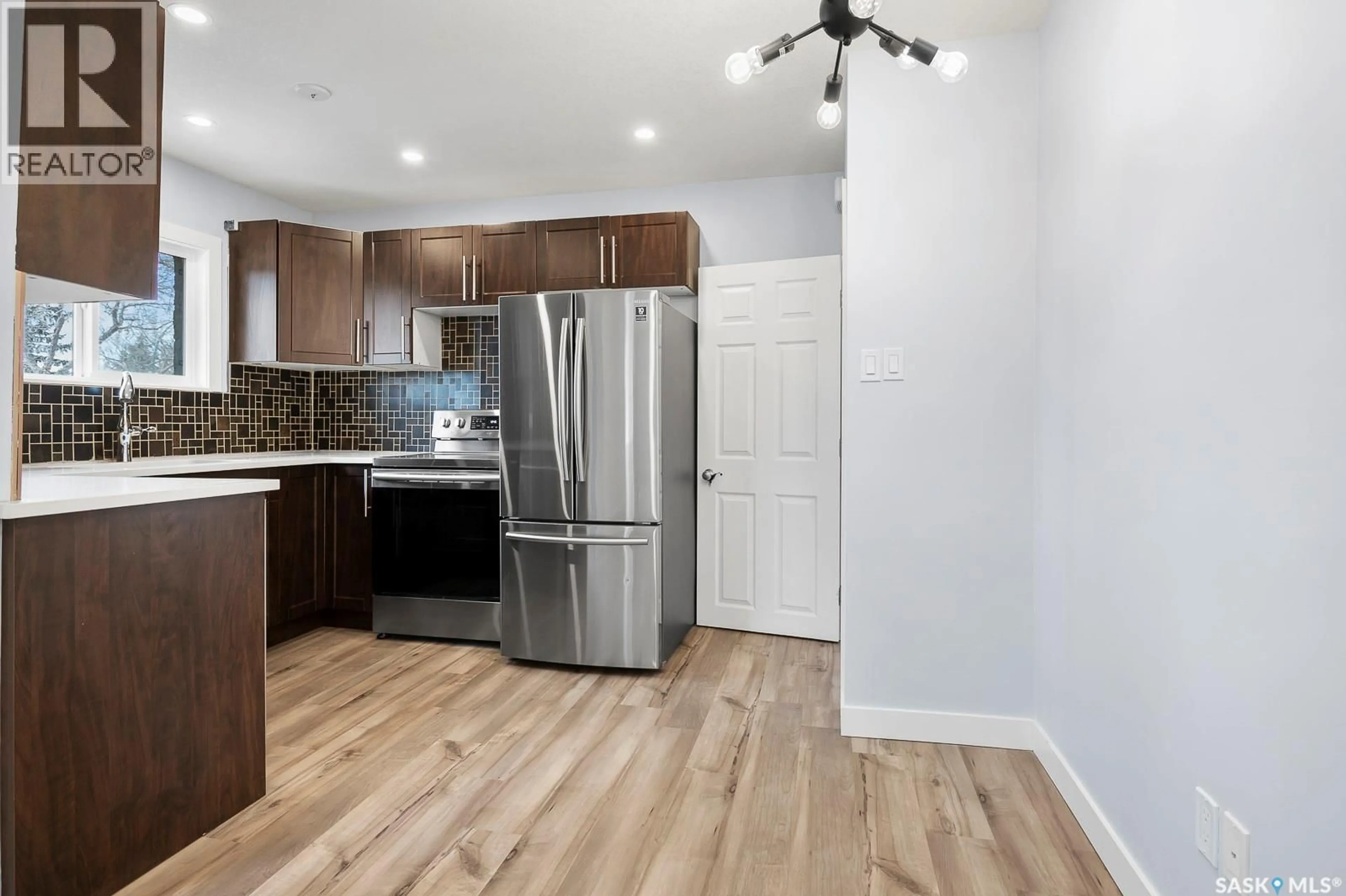 Open concept kitchen, wood/laminate floor for 2711 MACKAY STREET, Regina Saskatchewan S4N2T8