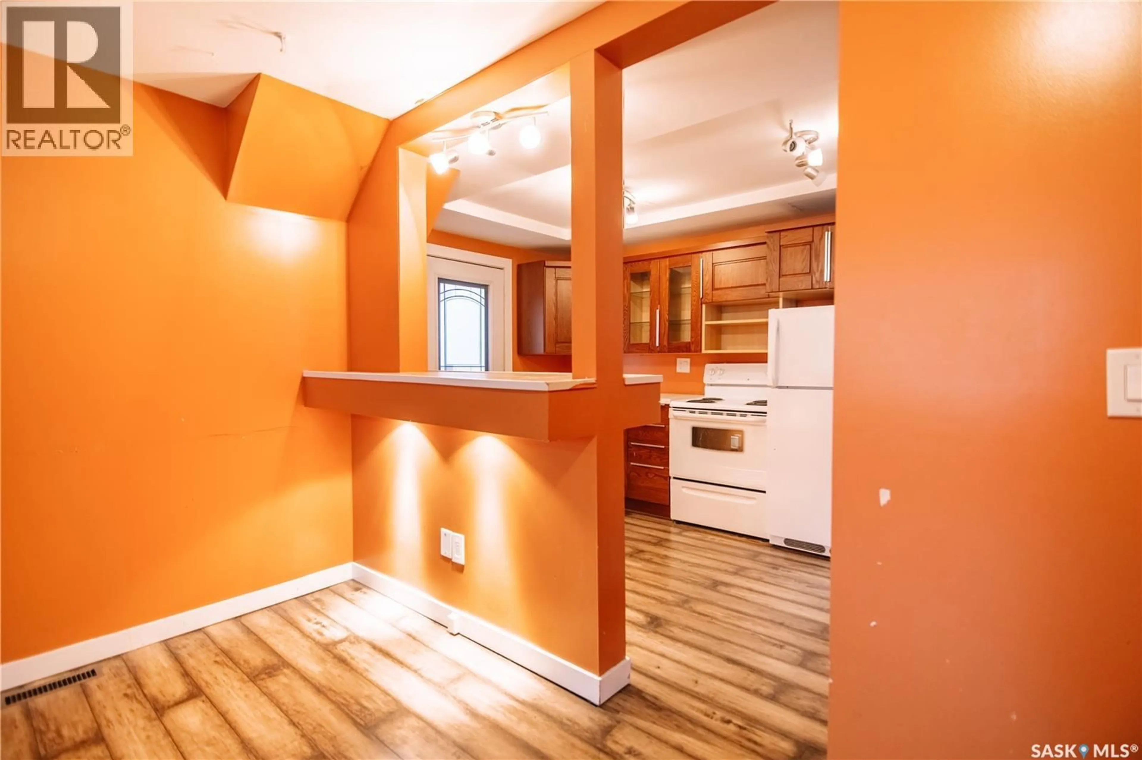 Open concept kitchen, wood/laminate floor for 721 KING STREET, Regina Saskatchewan S4T4E1
