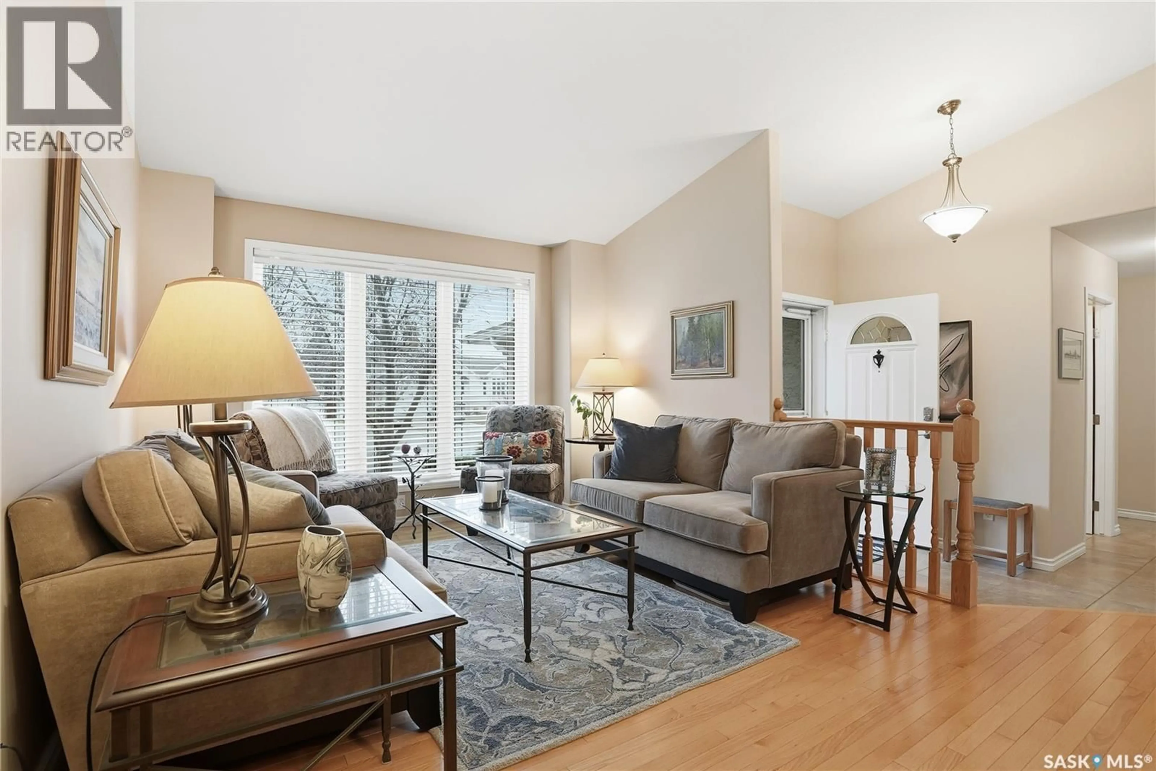 Living room with furniture, wood/laminate floor for 243 BRIARVALE BAY, Saskatoon Saskatchewan S7V1B8