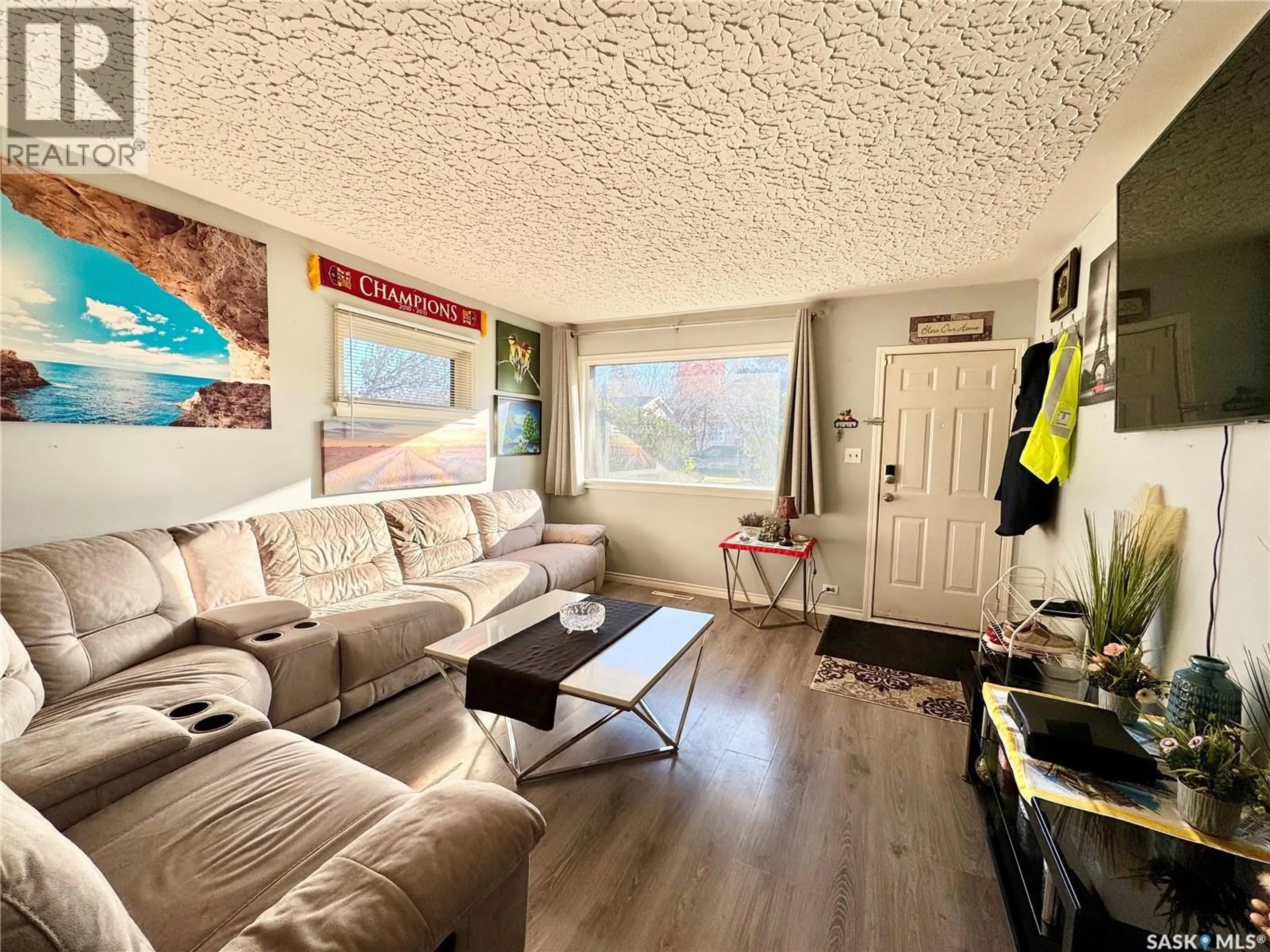 Living room with furniture, wood/laminate floor for 534 21ST STREET, Prince Albert Saskatchewan S6V1M4