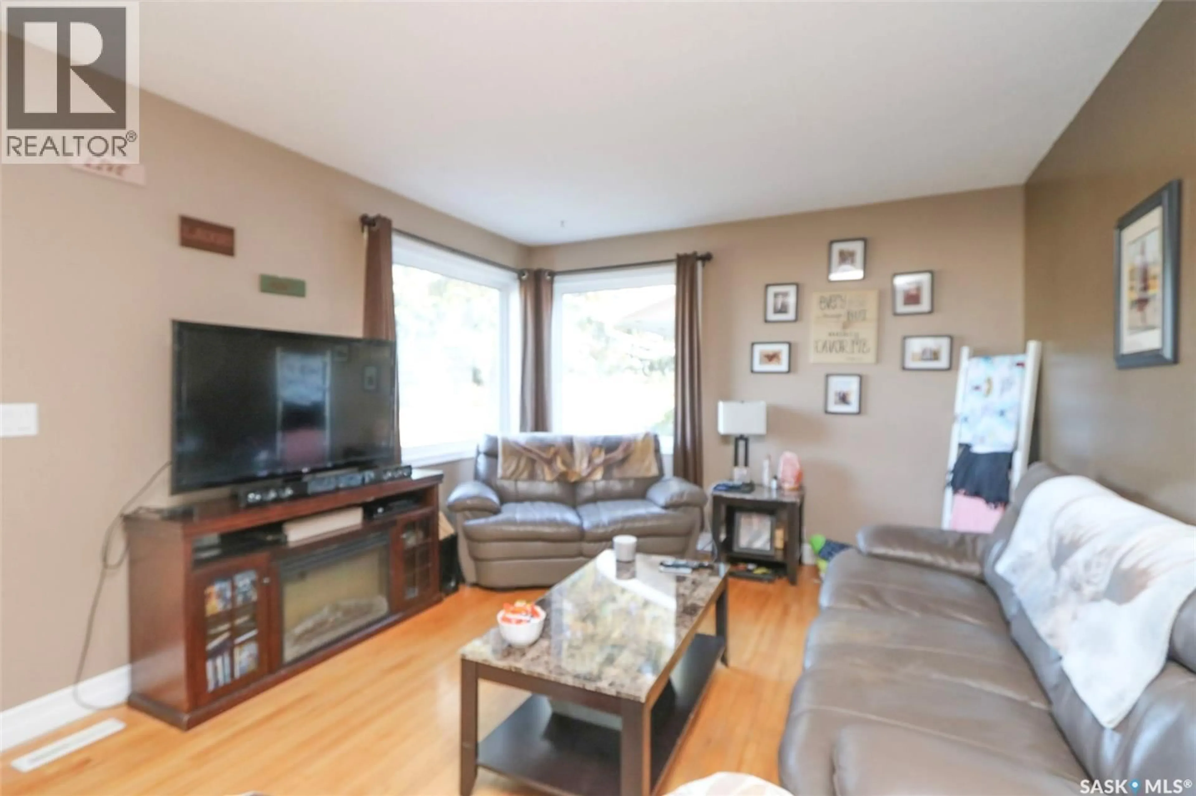 Living room with furniture, wood/laminate floor for 519 SEVENTH AVENUE, Melville Saskatchewan S0A2P0