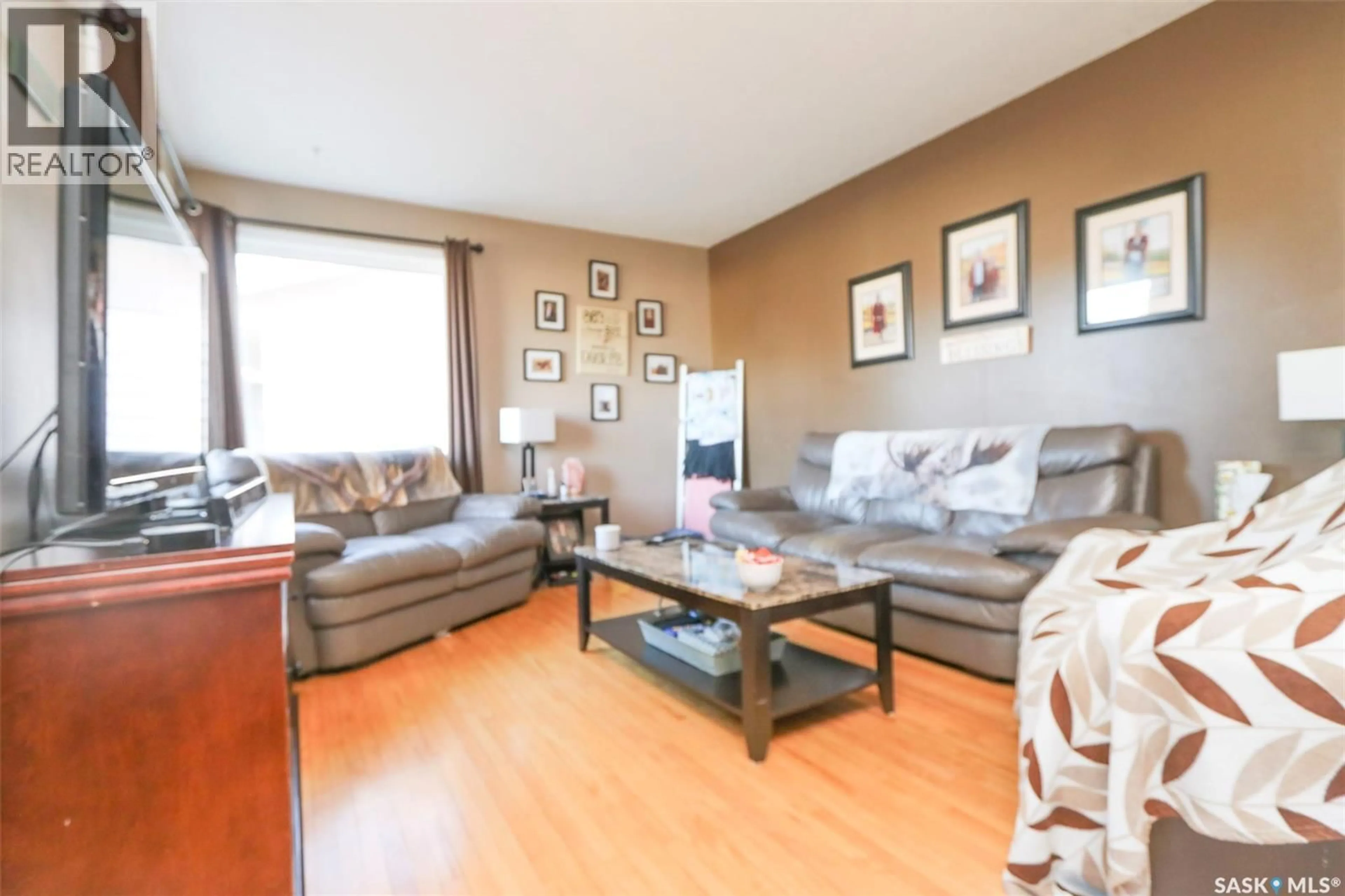Living room with furniture, wood/laminate floor for 519 SEVENTH AVENUE, Melville Saskatchewan S0A2P0