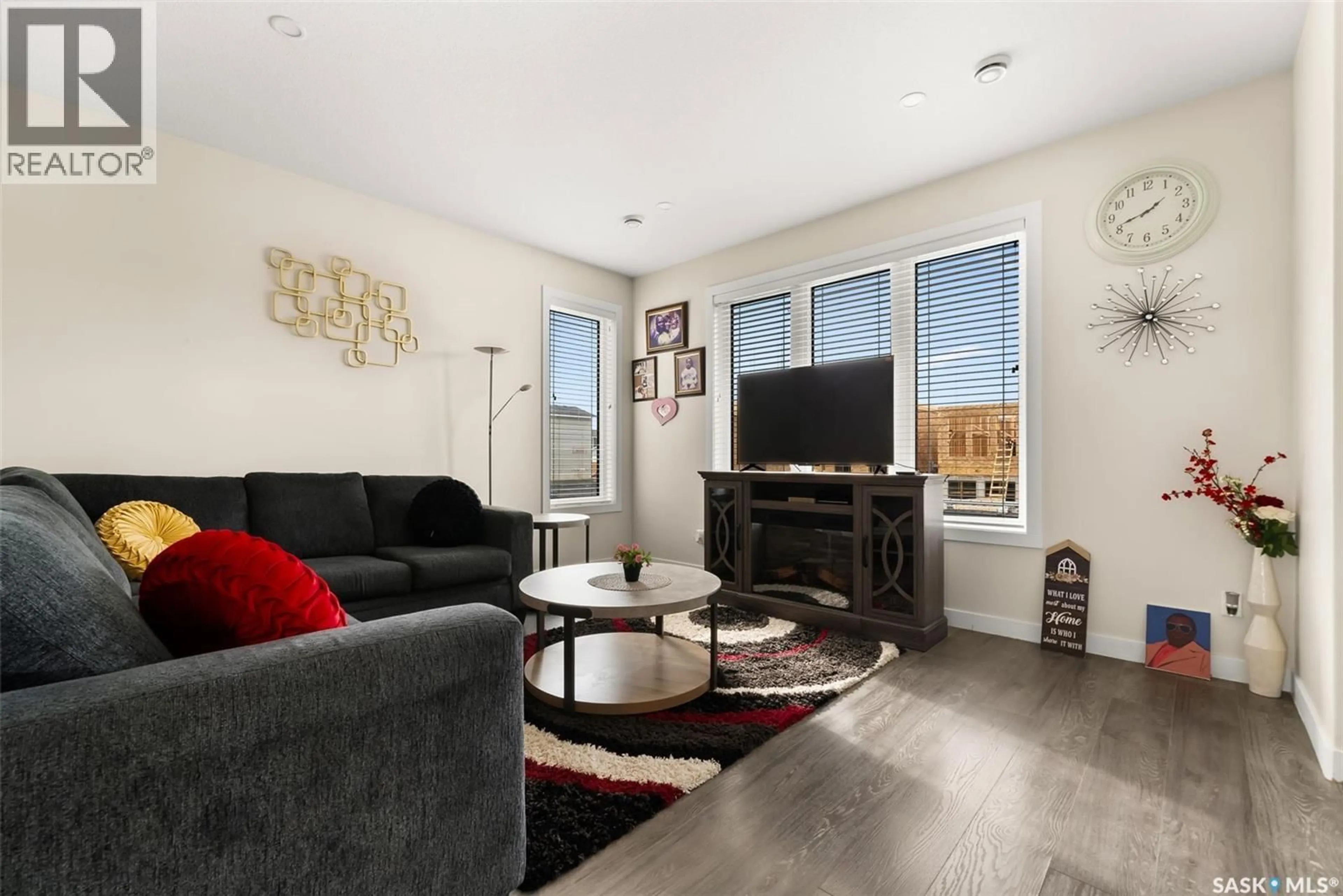 Living room with furniture, wood/laminate floor for 1157 POLEY STREET, Regina Saskatchewan S4X0K2