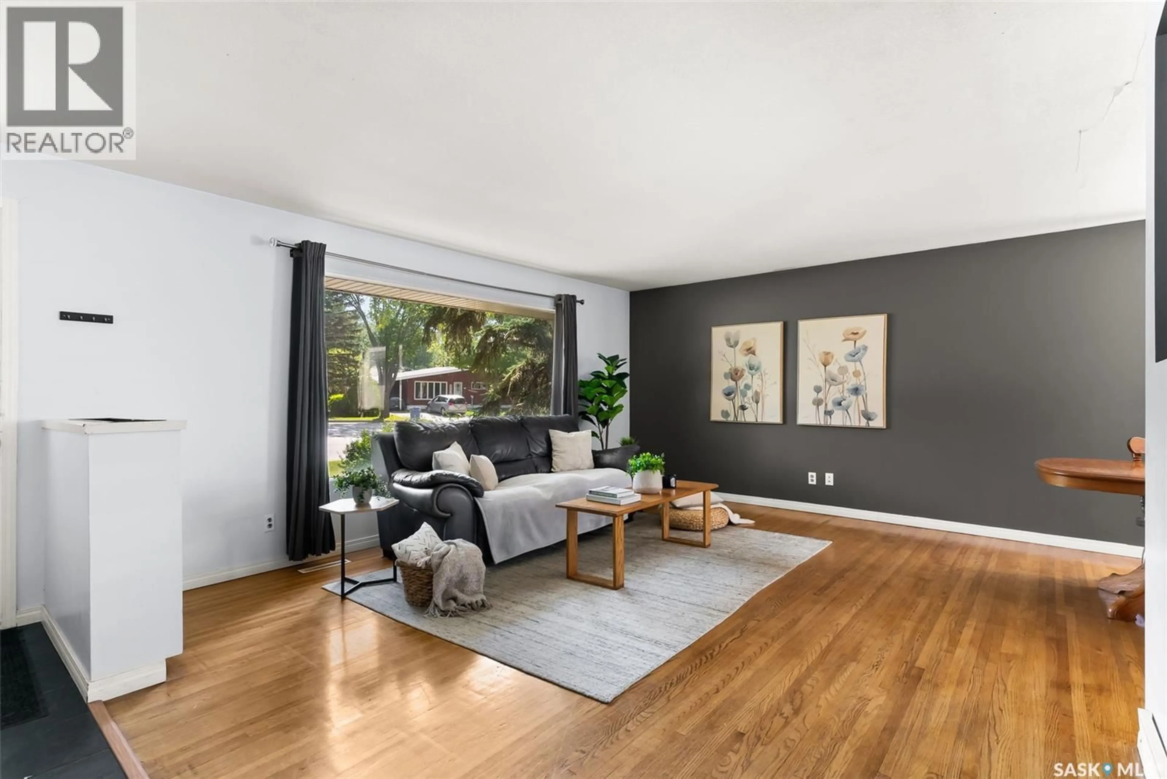 Living room with furniture, wood/laminate floor for 12 MASSEY ROAD, Regina Saskatchewan S4S4M7