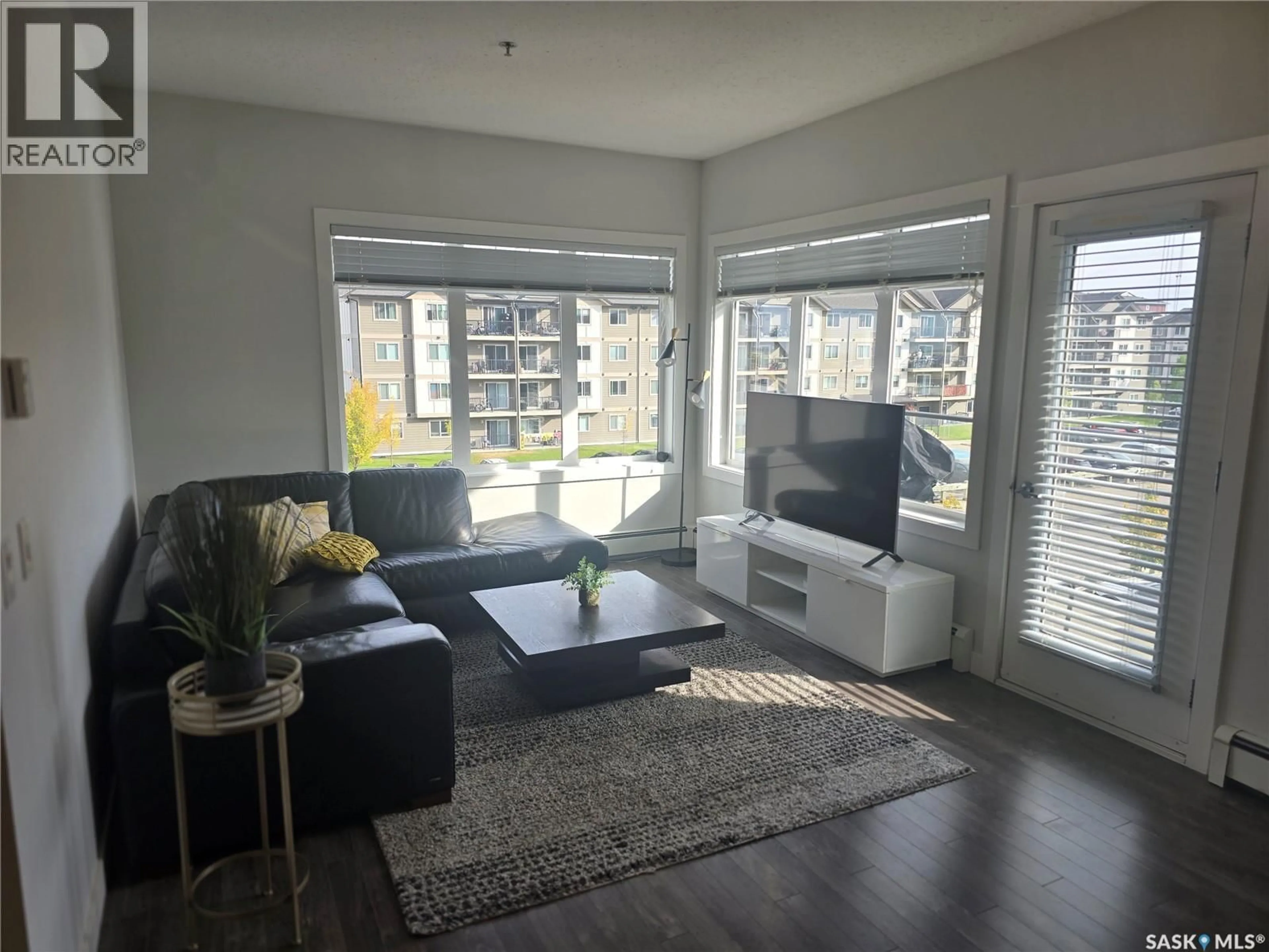 Living room with furniture, wood/laminate floor for 310 714 HART ROAD, Saskatoon Saskatchewan S7M1L2