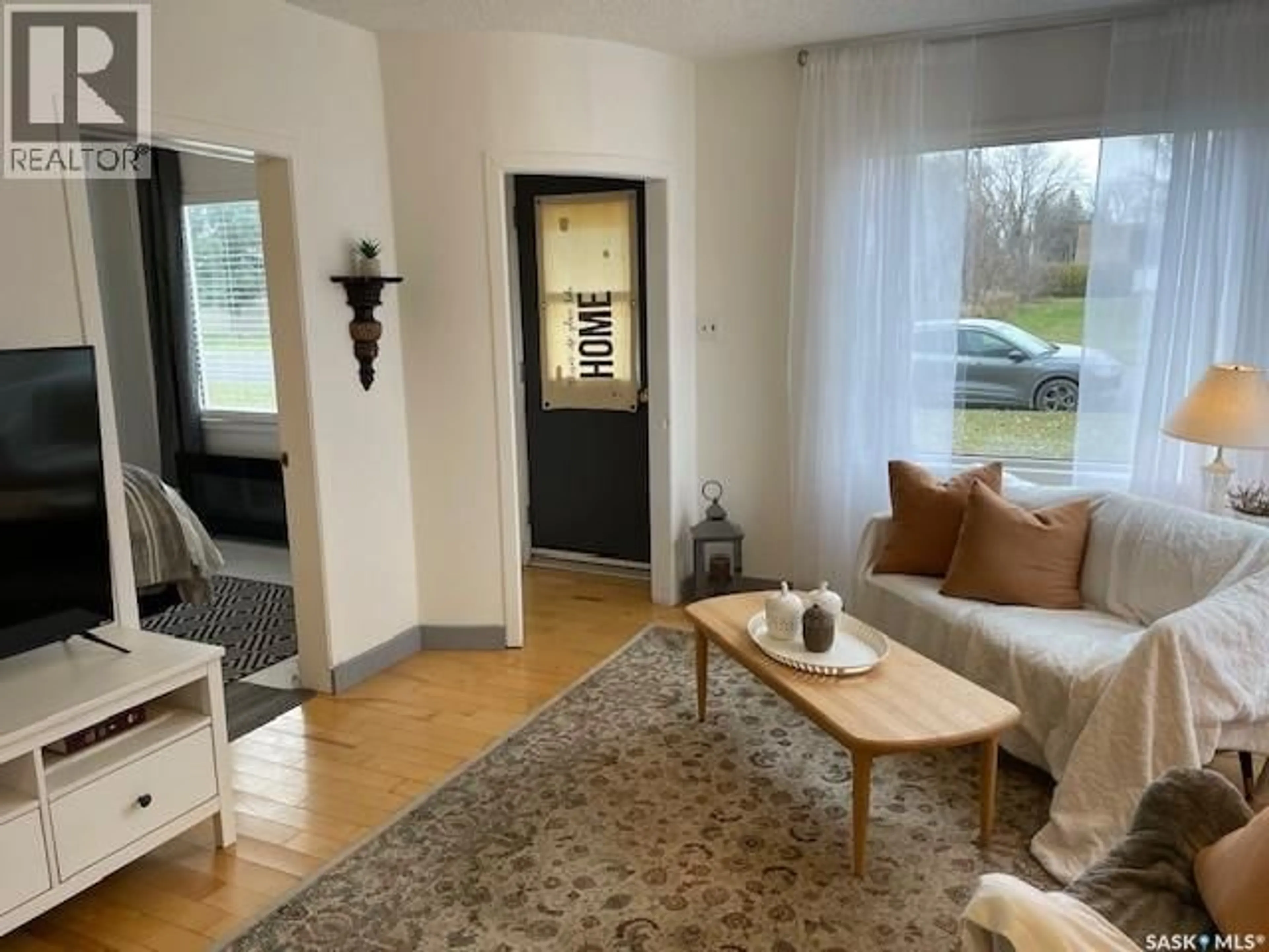 Living room with furniture, wood/laminate floor for 410 1ST STREET, Kipling Saskatchewan S0G2S0