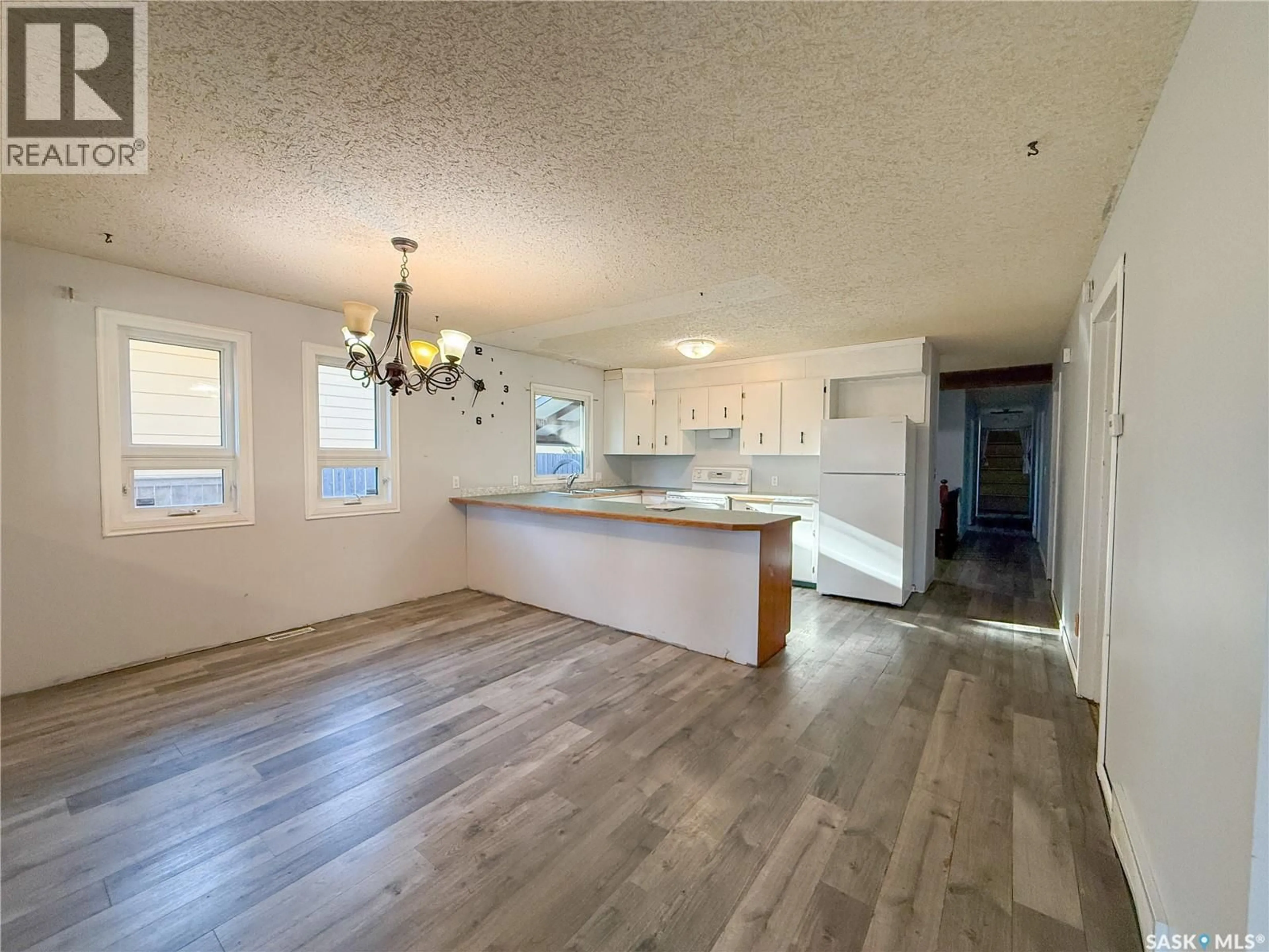 Open concept kitchen, wood/laminate floor for 1681 104TH STREET, North Battleford Saskatchewan S9A1P6