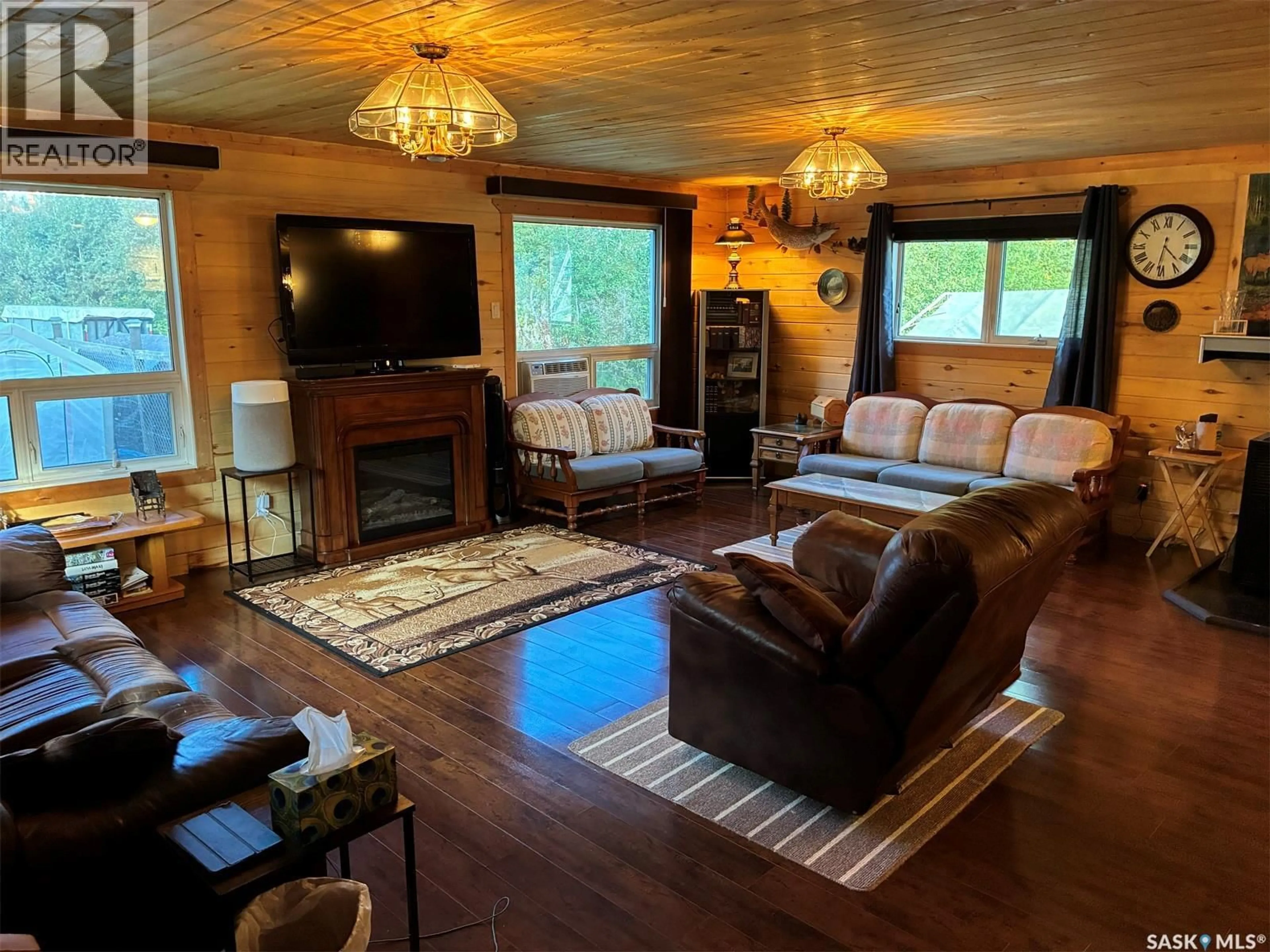 Living room with furniture, wood/laminate floor for Cole Bay Saskatchewan S0M0M0