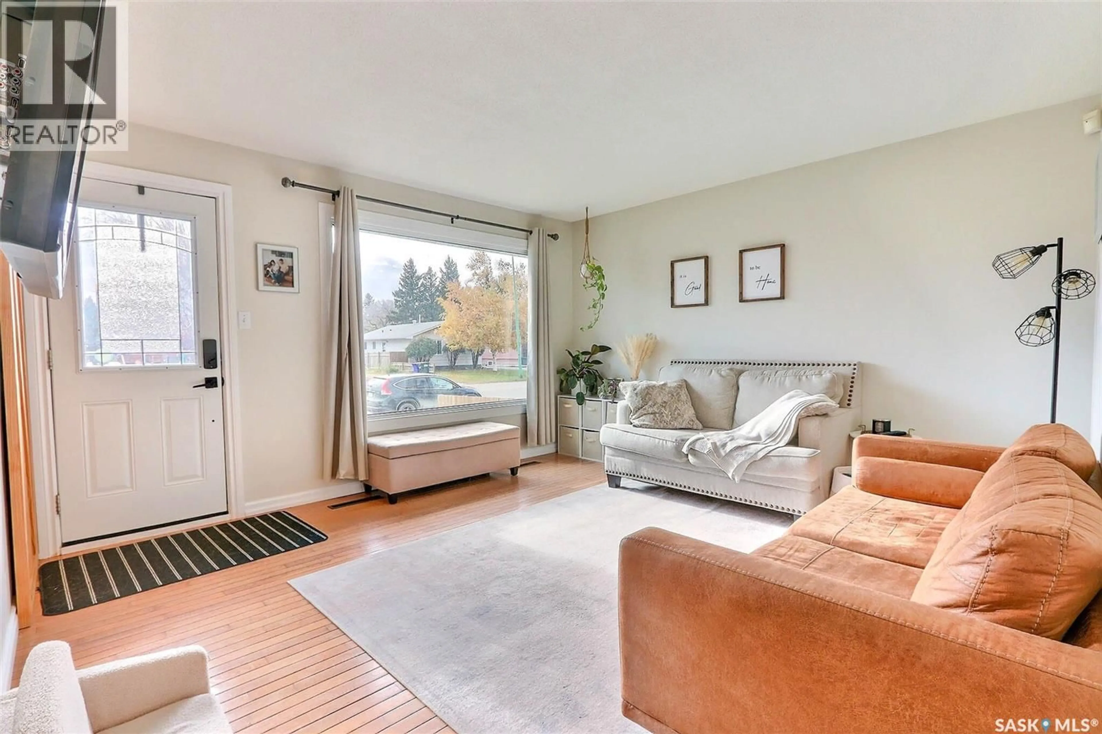 Living room with furniture, wood/laminate floor for 1052 4TH STREET, Prince Albert Saskatchewan S6V0K9