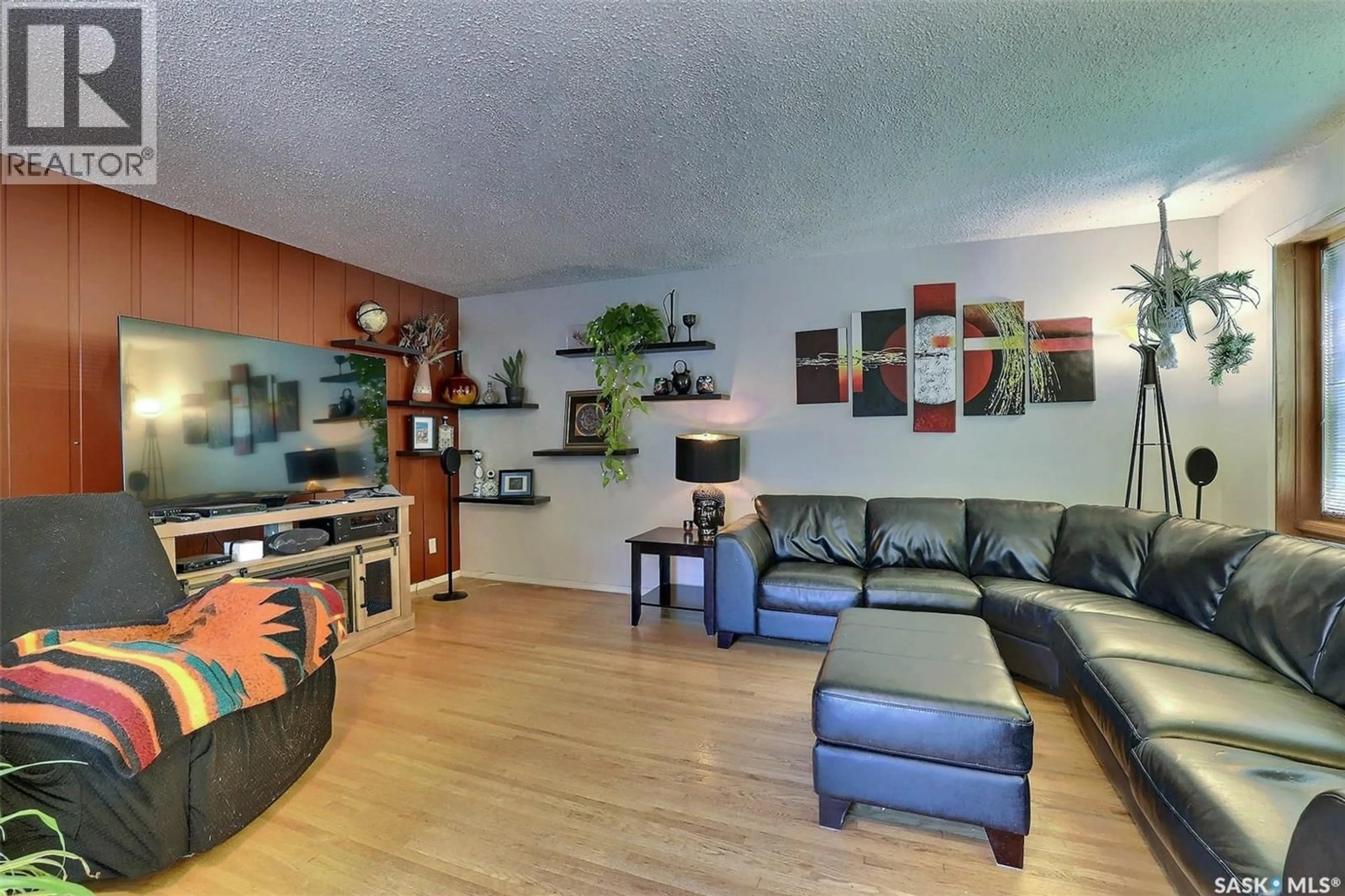 Living room with furniture, wood/laminate floor for 3428 WASCANA STREET, Regina Saskatchewan S4S2H3