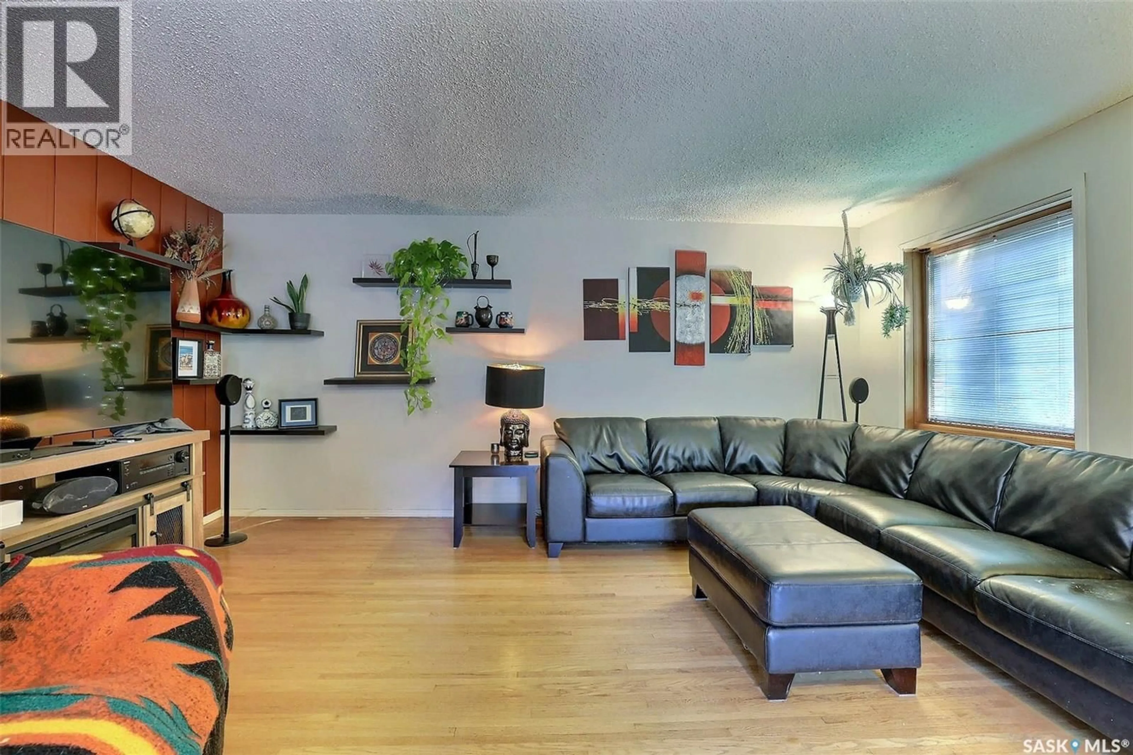 Living room with furniture, wood/laminate floor for 3428 WASCANA STREET, Regina Saskatchewan S4S2H3