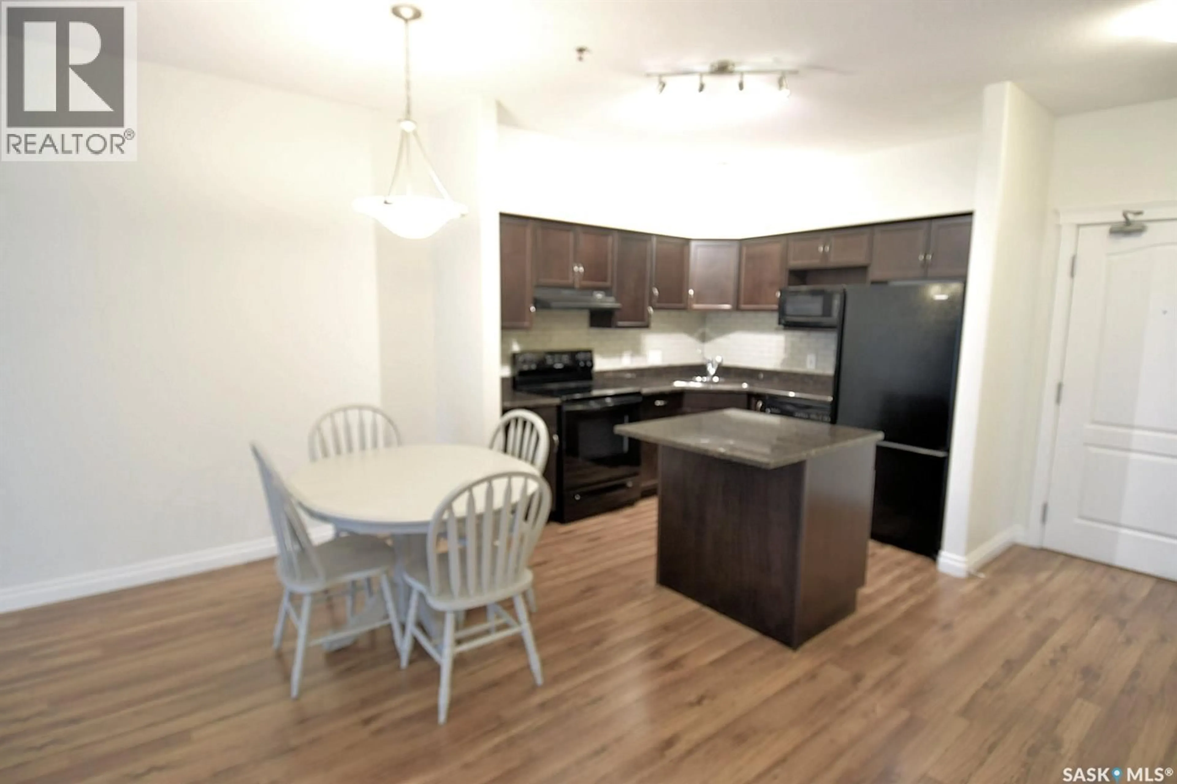 Open concept kitchen, wood/laminate floor for #110 - 363 NELSON ROAD, Saskatoon Saskatchewan S7S1P2